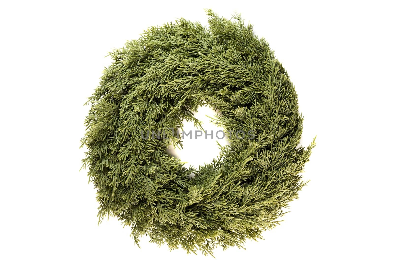 Christmas wreath made of artificial spruce branches for home decoration, on a white background