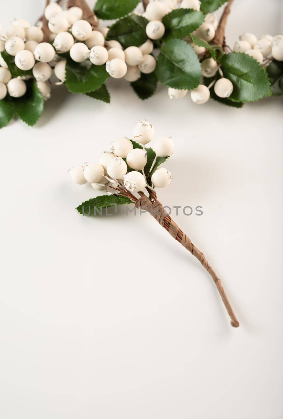 Artificial berries on a wire for needlework and decoration of gifts, wreaths on white background