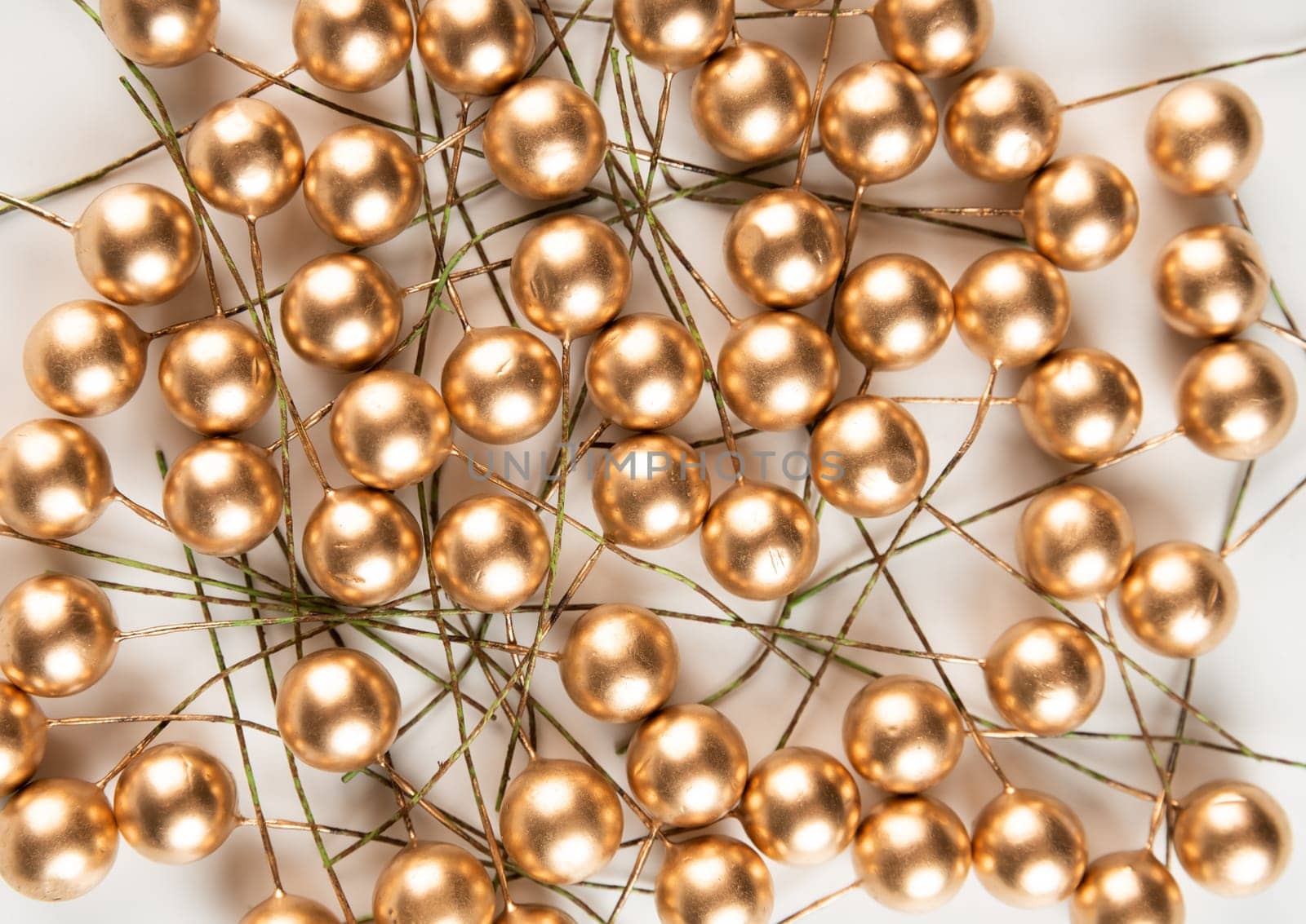 Artificial berries on a wire for needlework and decoration of gifts, wreaths on white background