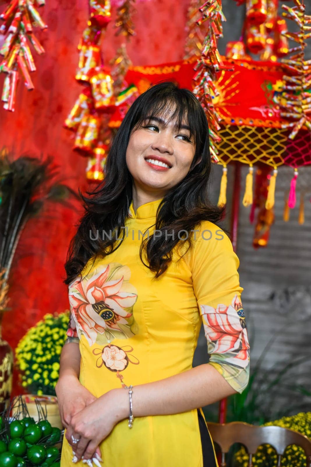 Beautiful Vietnamese woman in traditional vietnamese dress near red lanterns in Tet  Lunar New YearBeautiful Vietnamese woman in traditional vietnamese dress near red lanterns in Tet  Lunar New Year