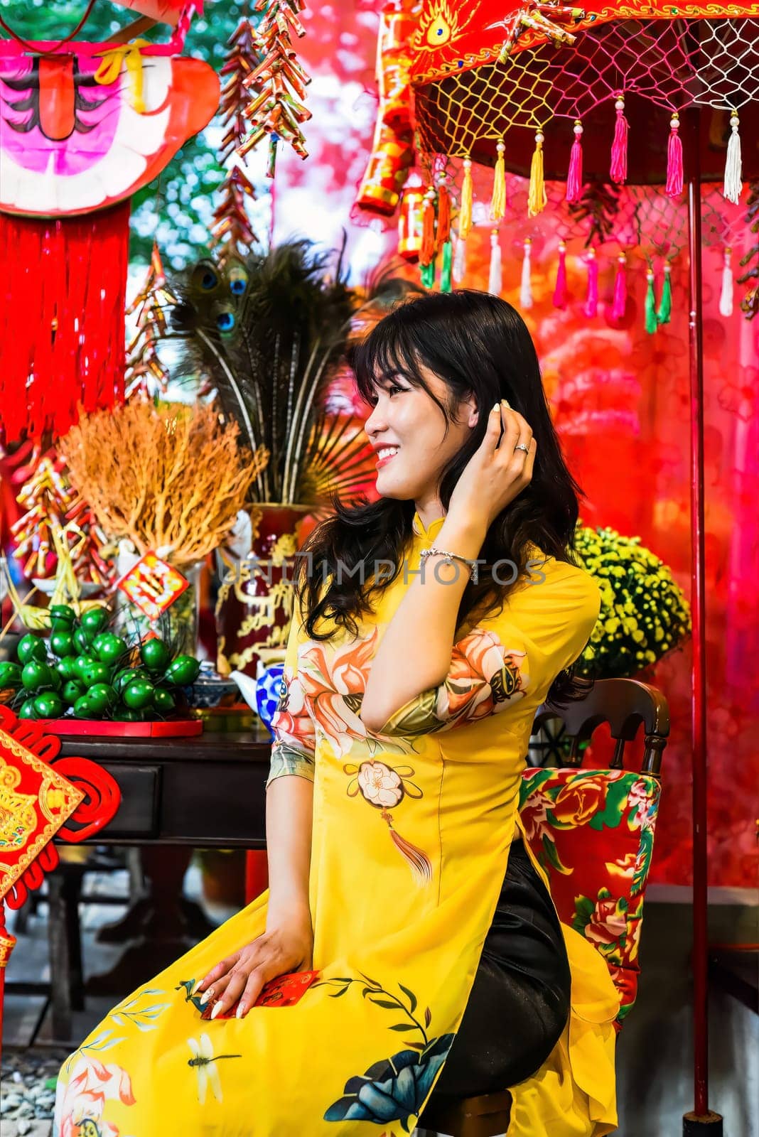 Beautiful Vietnamese woman in traditional vietnamese dress near red lanterns in Tet  Lunar New YearBeautiful Vietnamese woman in traditional vietnamese dress near red lanterns in Tet  Lunar New Year