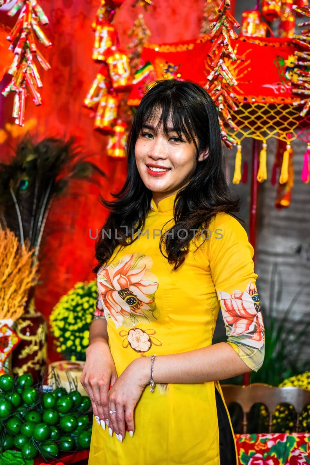 Beautiful Vietnamese woman in traditional vietnamese dress near red lanterns in Tet  Lunar New YearBeautiful Vietnamese woman in traditional vietnamese dress near red lanterns in Tet  Lunar New Year