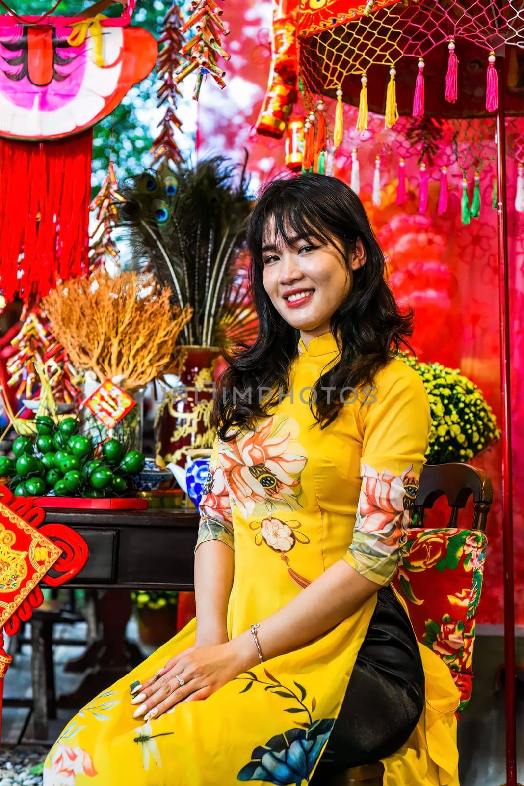 Beautiful Vietnamese woman in traditional vietnamese dress near red lanterns in Tet  Lunar New YearBeautiful Vietnamese woman in traditional vietnamese dress near red lanterns in Tet  Lunar New Year