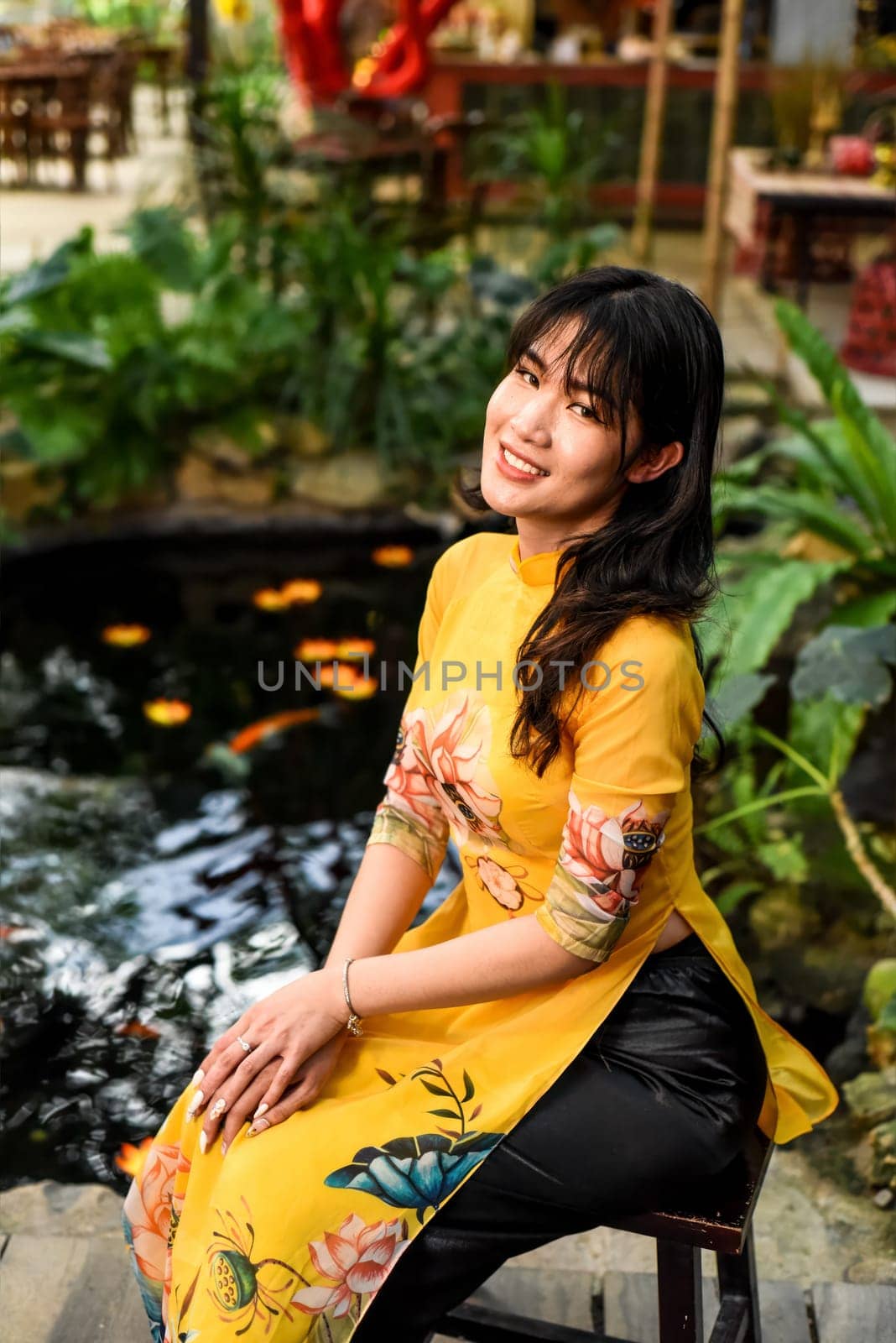 Beautiful Vietnamese woman in traditional vietnamese dress near red lanterns in Tet  Lunar New YearBeautiful Vietnamese woman in traditional vietnamese dress near red lanterns in Tet  Lunar New Year