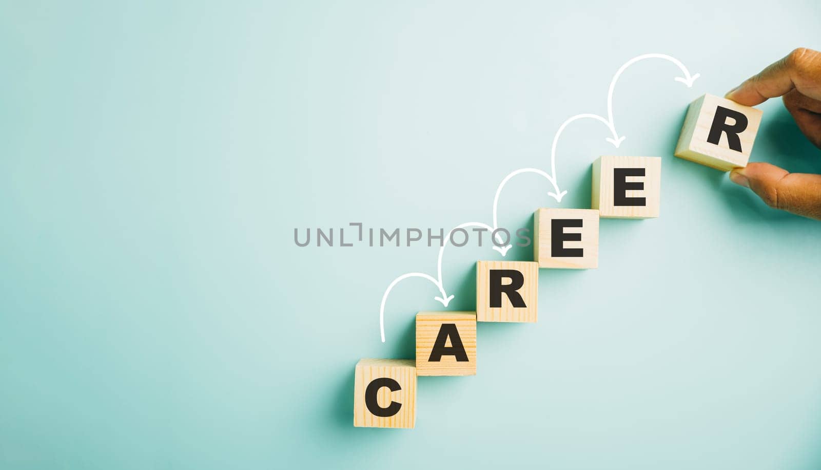 Hand meticulously positions a wooden cube block adorned with the word CAREER. This image symbolizes the opportunities, challenges, and growth associated with business success