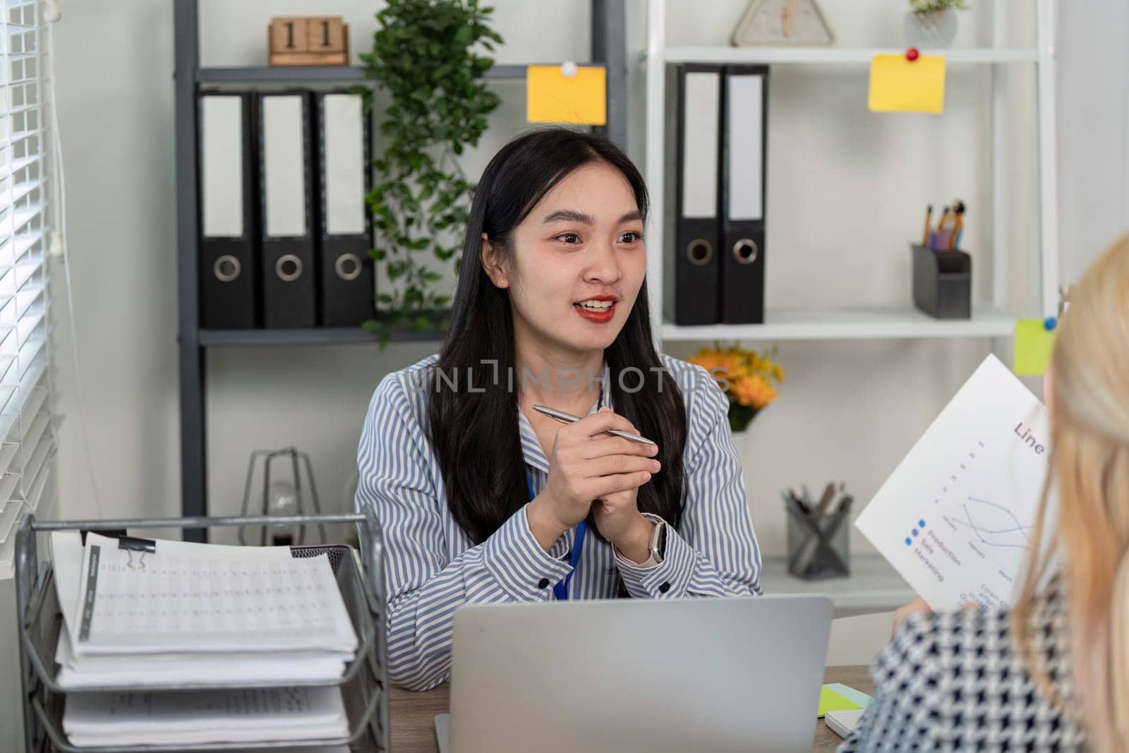 A diverse team collaborates on tax planning and analysis, showcasing teamwork and professional engagement in a modern office.