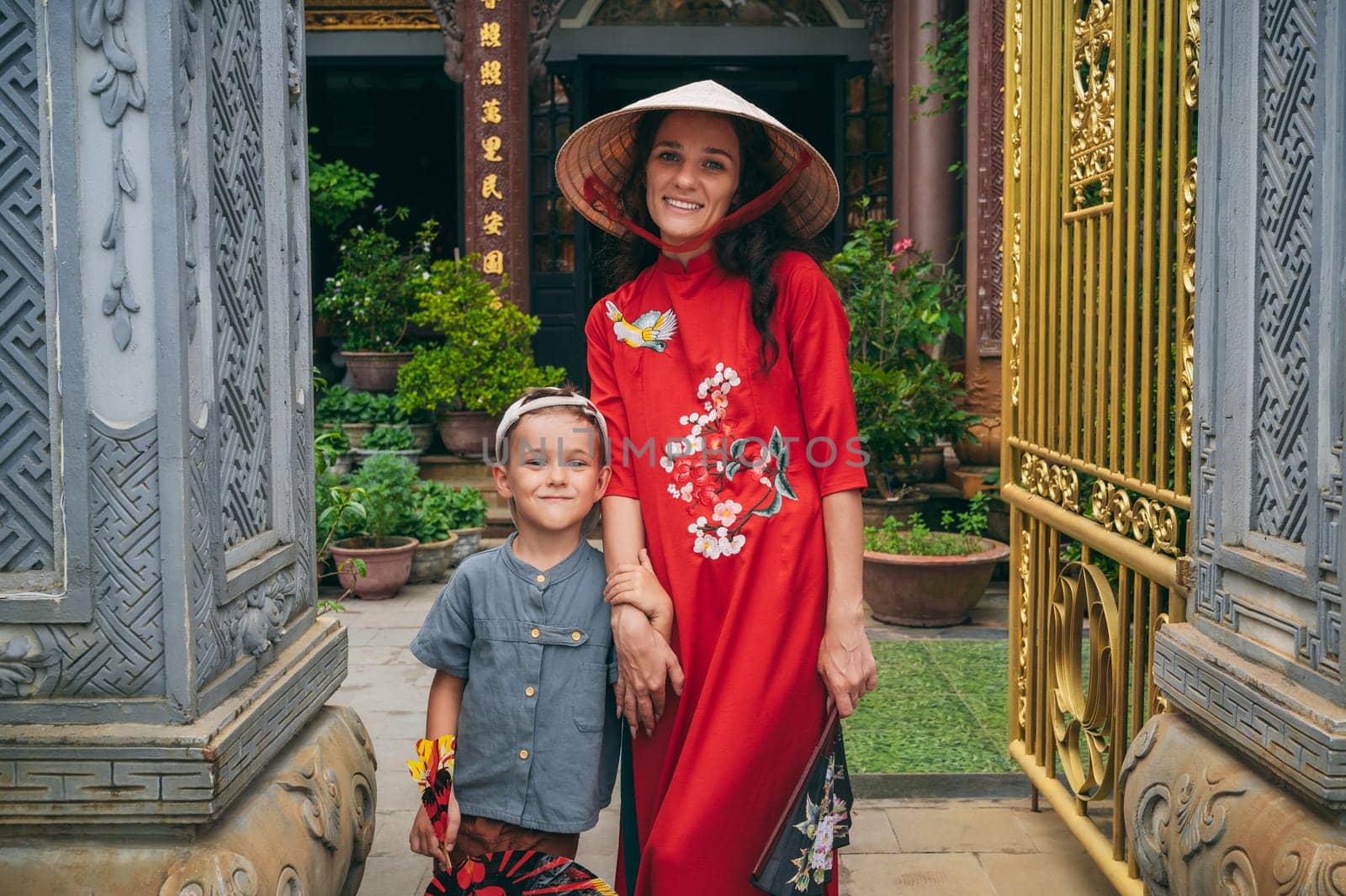 happy woman mother with a boy son tourists travelers at a Buddhist temple in Vietnam in Asia