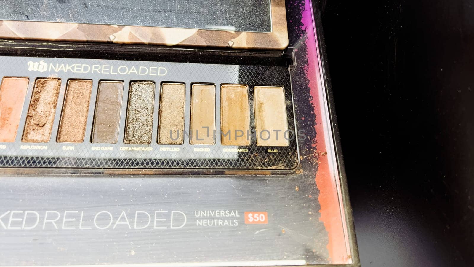 Denver, Colorado, USA-December 31, 2023-Beauty products are displayed with sophistication, featuring shimmering blush palettes, elegant lipsticks, and sleek foundations, reflecting luxury in the store mirrors.