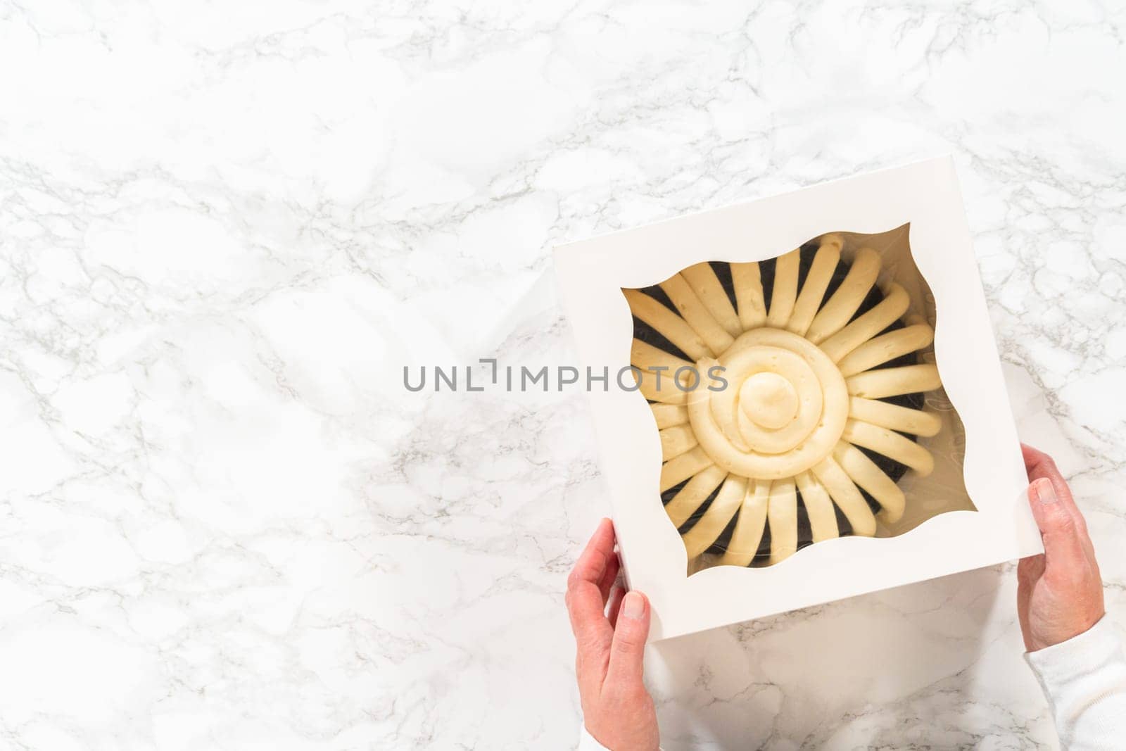 Flat lay. With care, the Chocolate Bundt Cake is packaged into a white paper box - ready for gifting to bring joy and indulgence to someone special.
