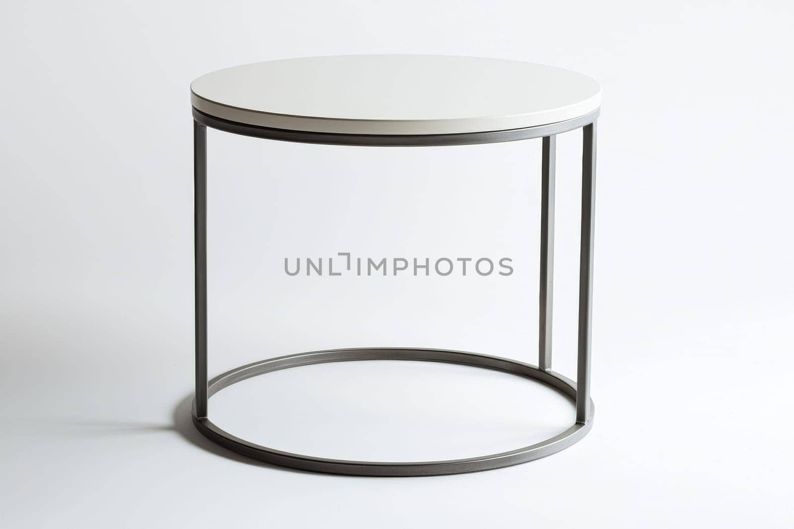 A sleek round table features a simple white top and a sturdy metal frame, perfect for contemporary interiors or casual gatherings.