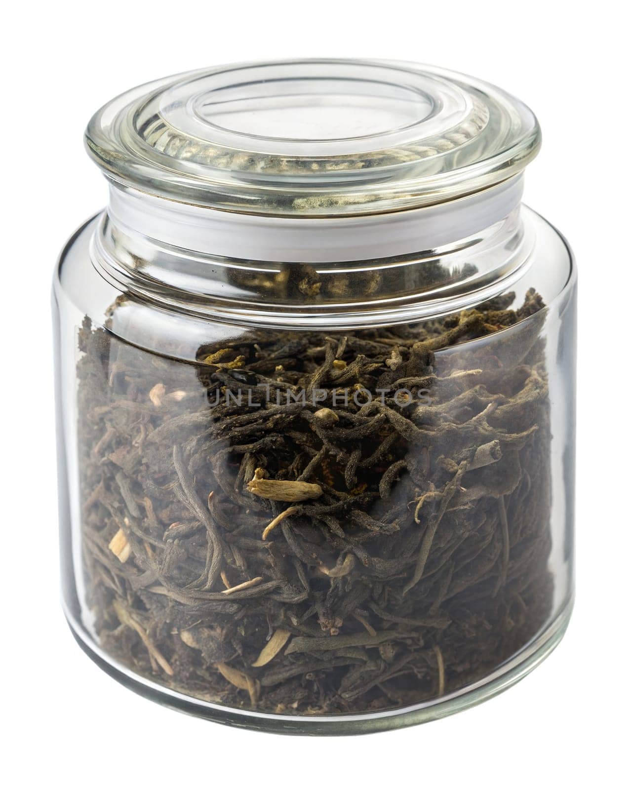 Dried oolong tea leaves stored in a transparent glass jar with a sealed lid. Traditional loose leaf tea for brewing. Isolated on white background