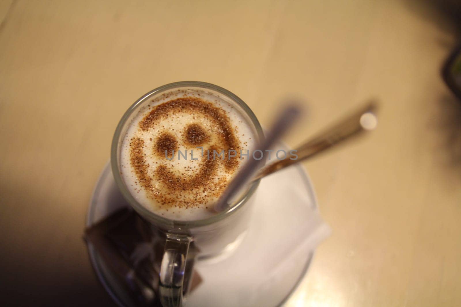 Imagine a delightful cup of coffee topped with beautiful smiley foam art, which is perfect for brightening your day