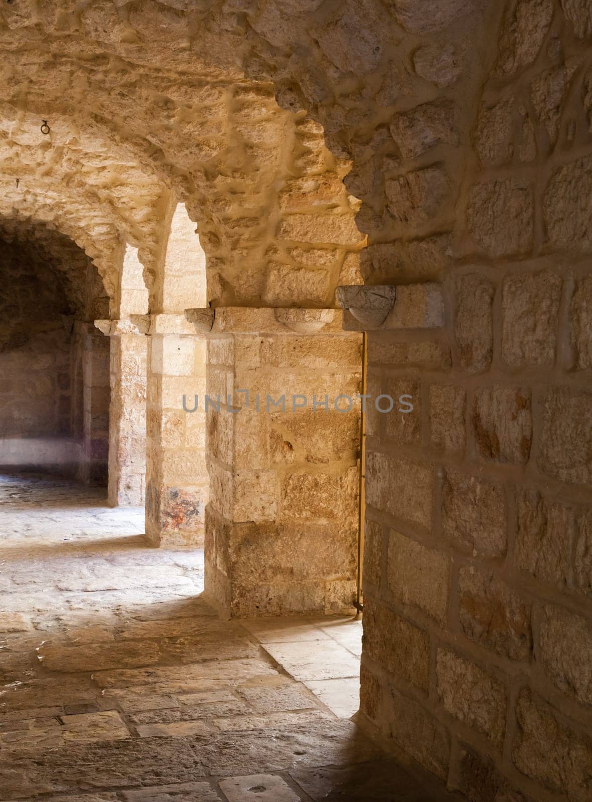 Beautiful brick stone archway with receding path in a church in Jerusalem