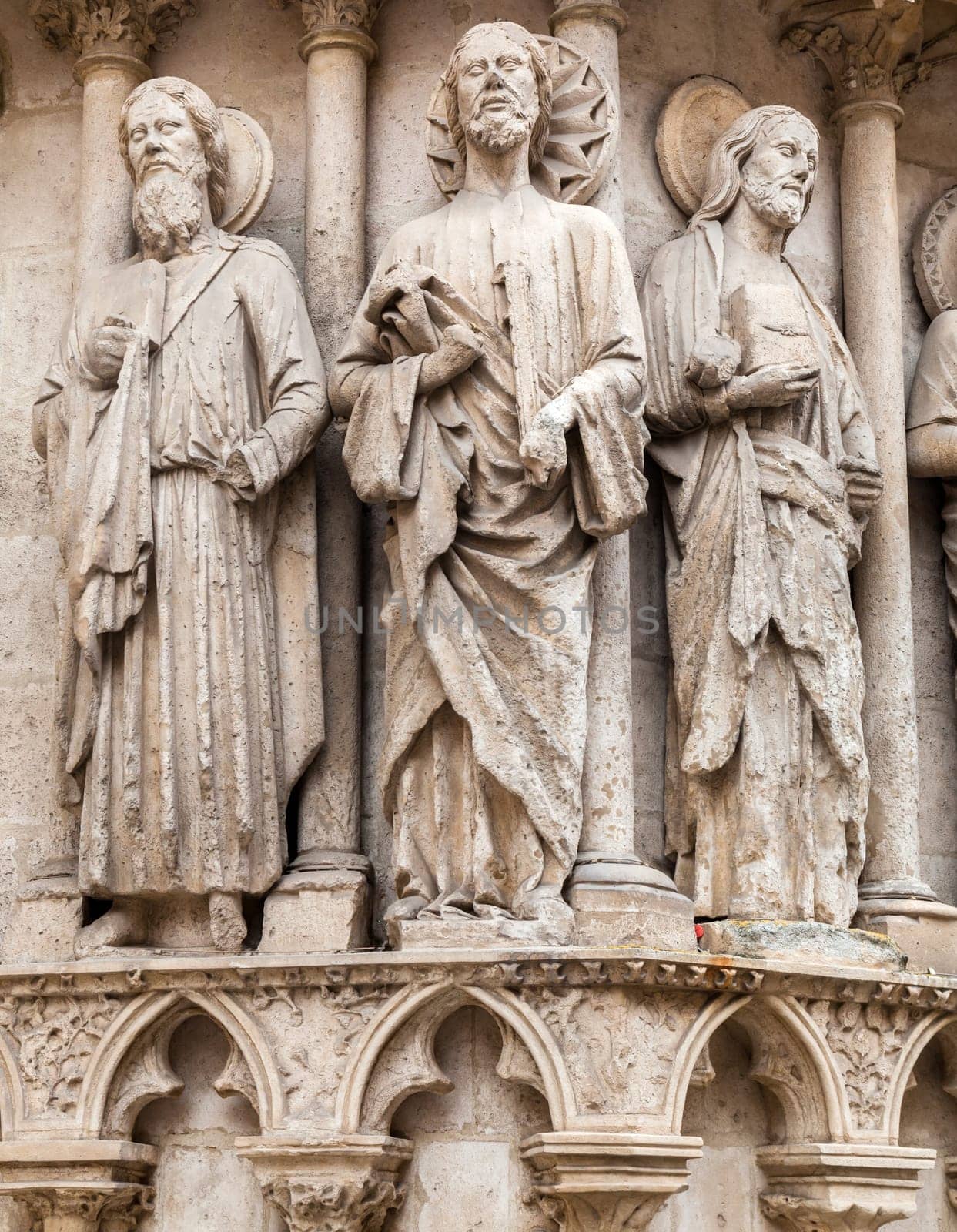 Intricate stone sculptures of religious figures enhance the architecture of the Burgos Cathedral, showcasing artistry.