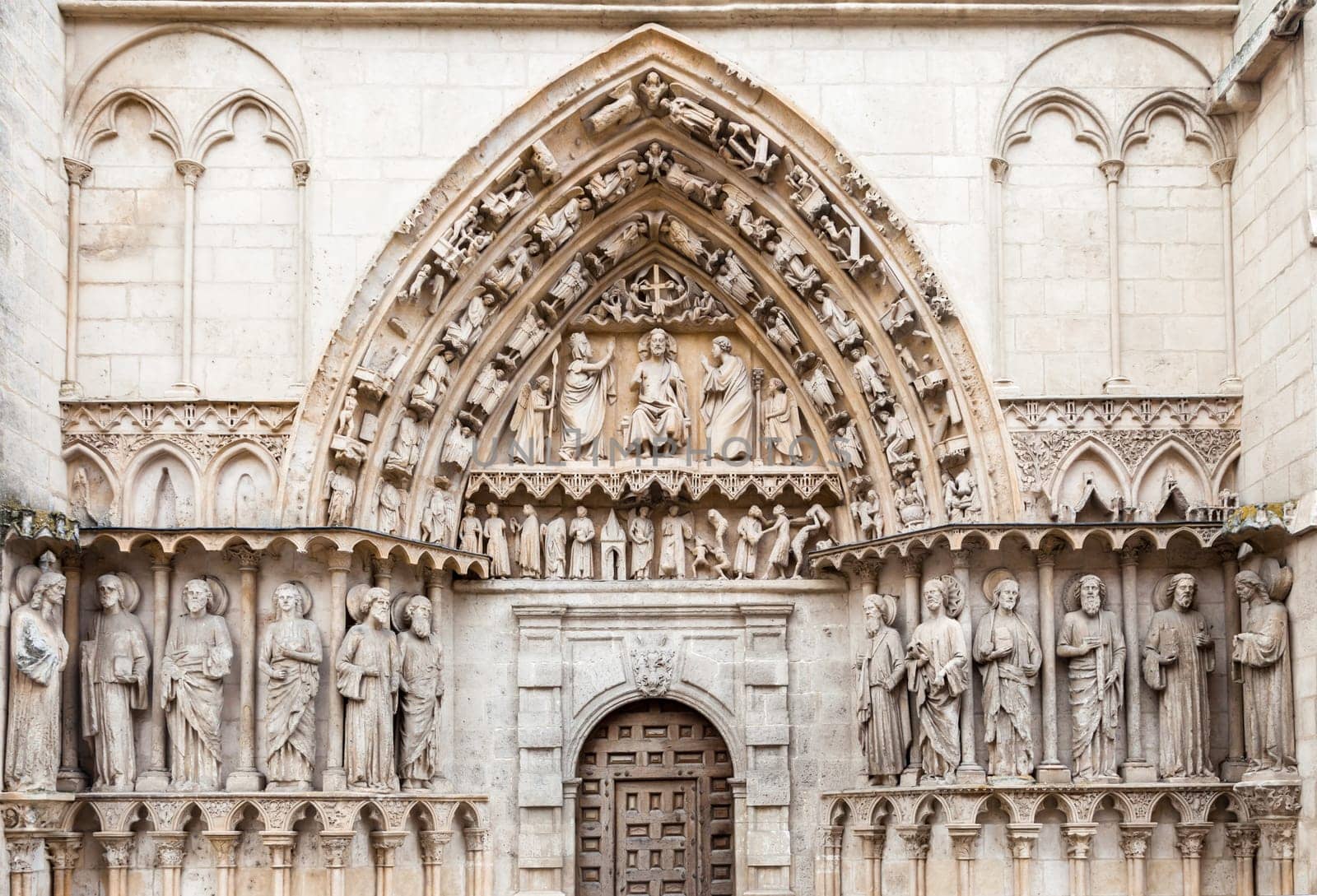 Detailed stone facade of the Cathedral in Burgos, Spain, with its gothic artwork.