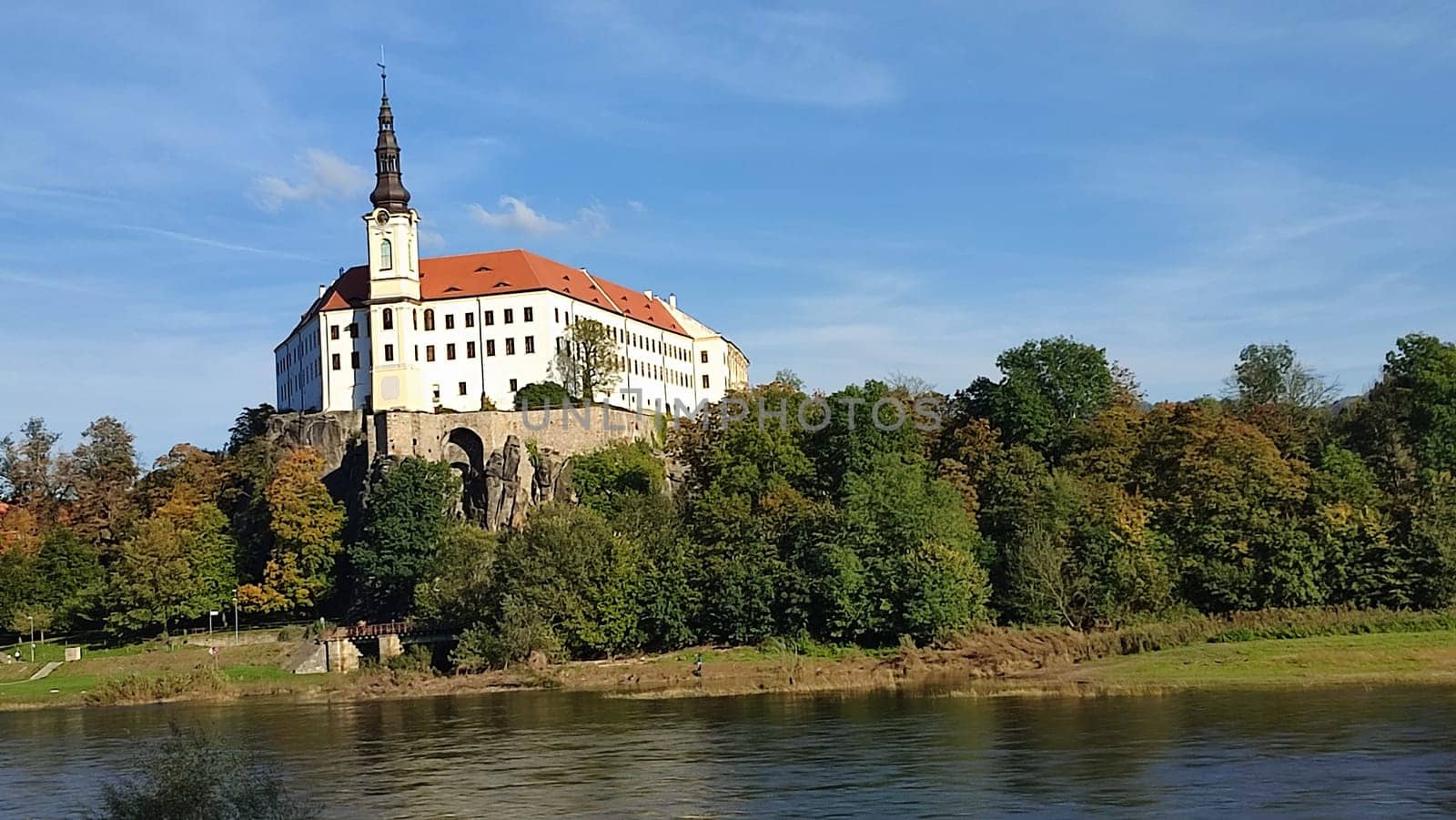 Castle riverside trees green nature summer autumn background landscape blue sky day. October 16 2024 Decin Czech Republic Europe travel places . High quality photo park outdoor