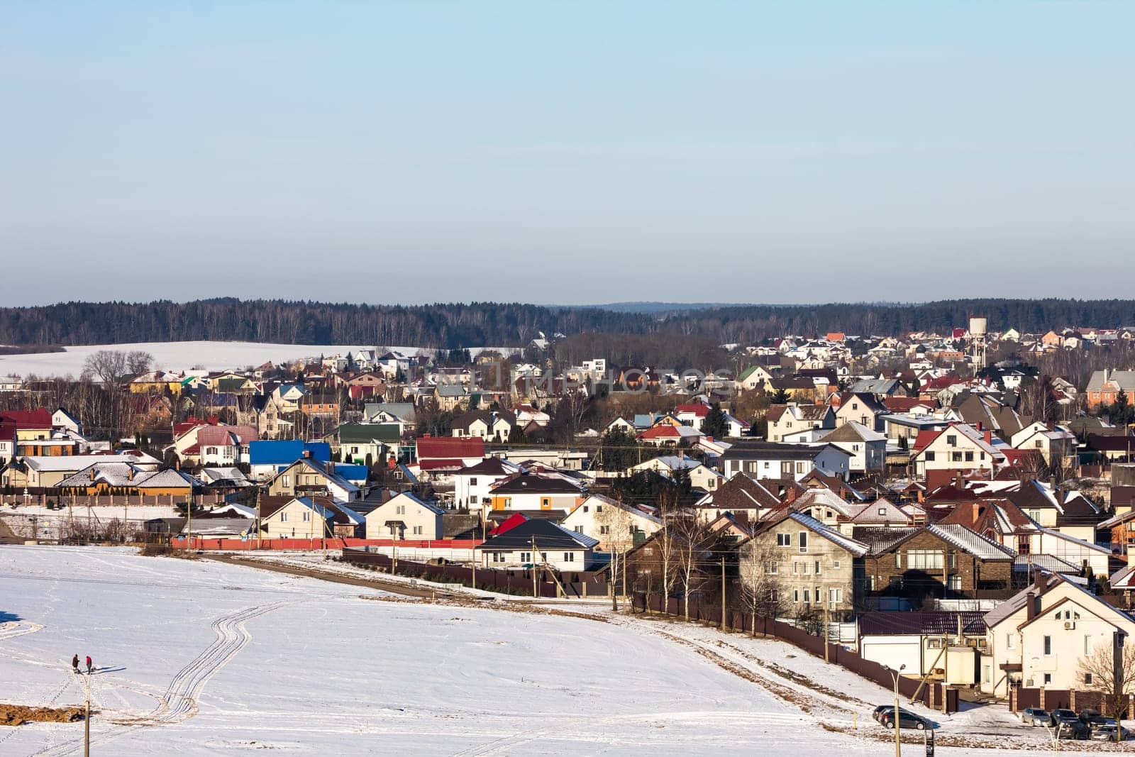 winter photography of a snowy suburban neighborhood, showcasing snow-covered houses and trees in a peaceful setting, perfect for seasonal marketing and landscape visuals.