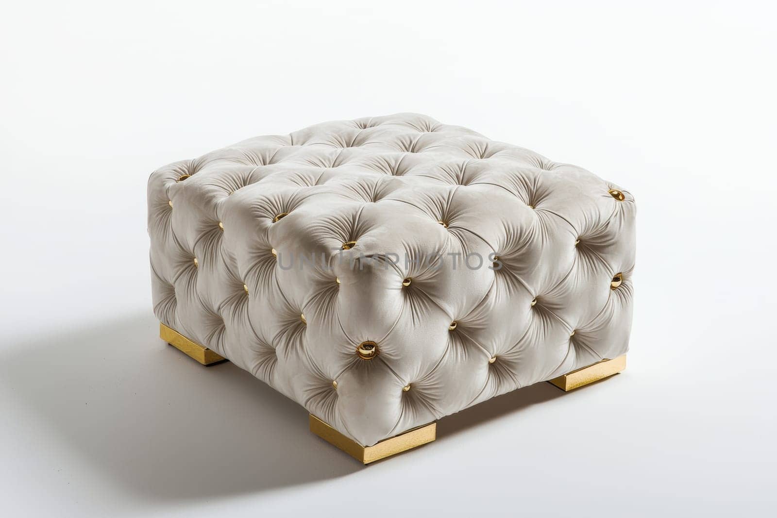 This stylish tufted ottoman features a neutral fabric and chic gold accents, ideal for enhancing contemporary interiors.