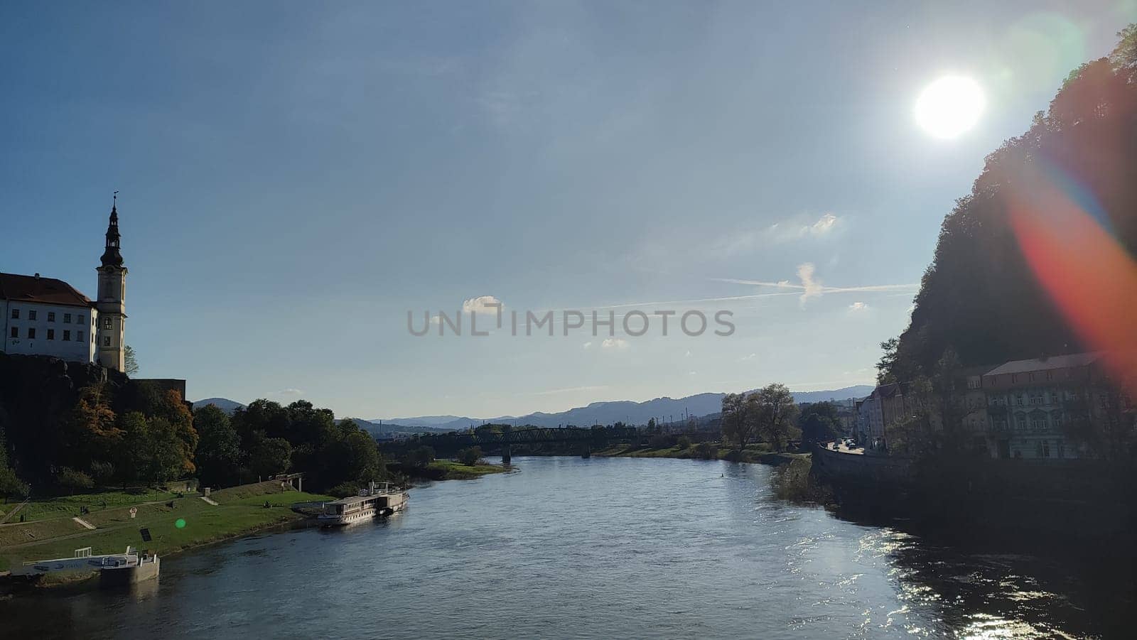 River sunlight castle blue sky landscape background summer day evening landscape city centre nature water. October 16 2024 Decin Czech Republic Europe travel places . High quality photo