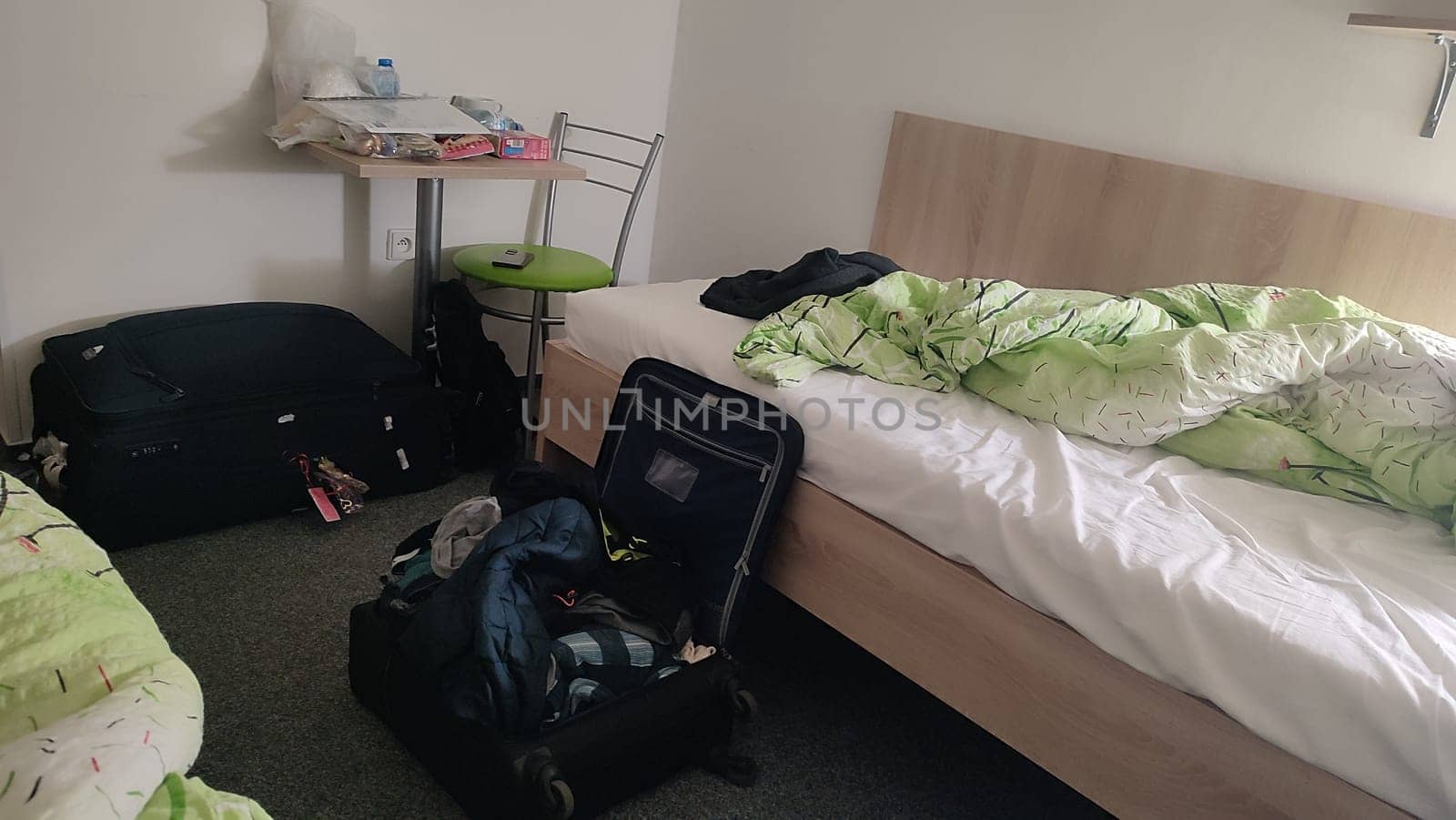 Messy suitcase bedroom house hotel apartment wooden bad travel tourism room indoor furniture. High quality photo. October 16 2024 Decin Czech Republic Europe travel places