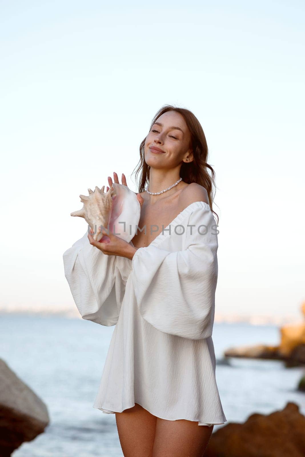 A woman standing in front of water. High quality photo