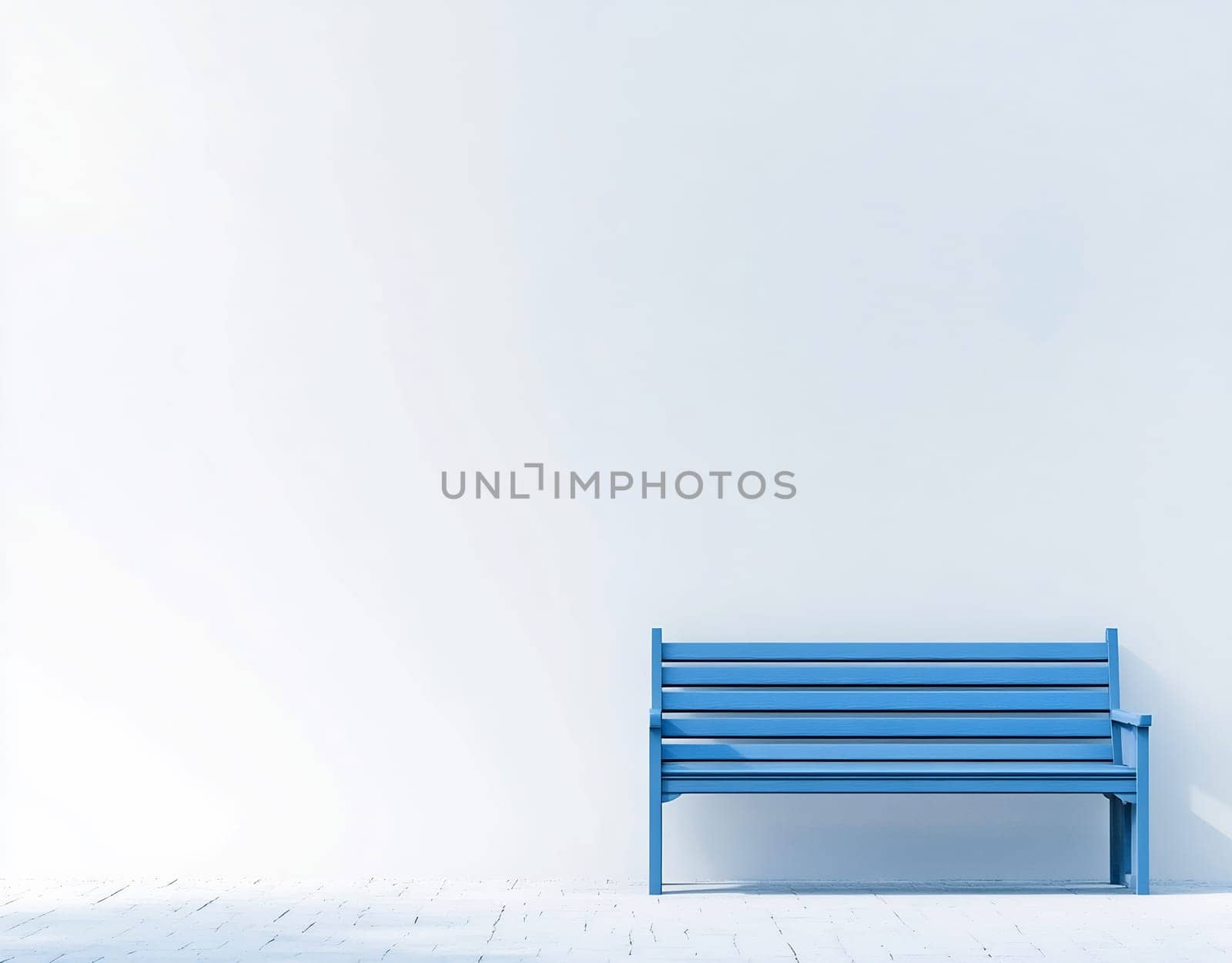 A bright blue bench is positioned against a large white wall in a minimalist space, creating a serene and open atmosphere.