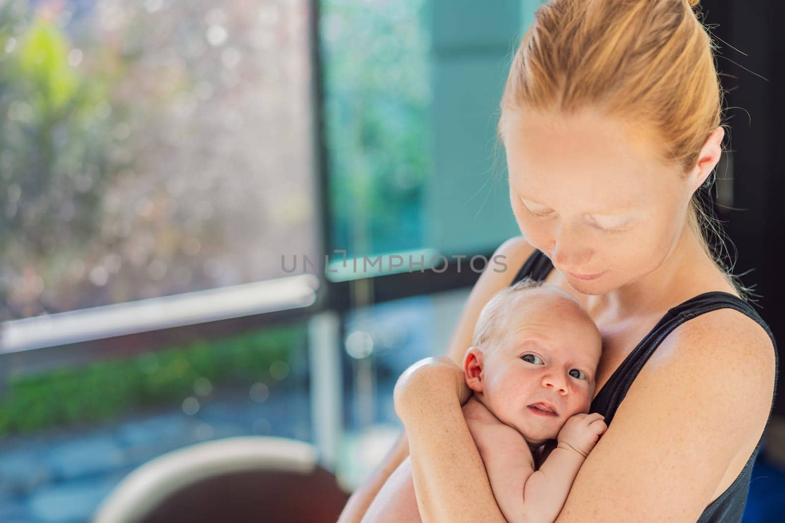 A mother lovingly embraces her newborn baby, holding them close to her chest. A tender moment of warmth, security, and deep maternal love, symbolizing bonding, comfort, and the unbreakable connection between mother and child.