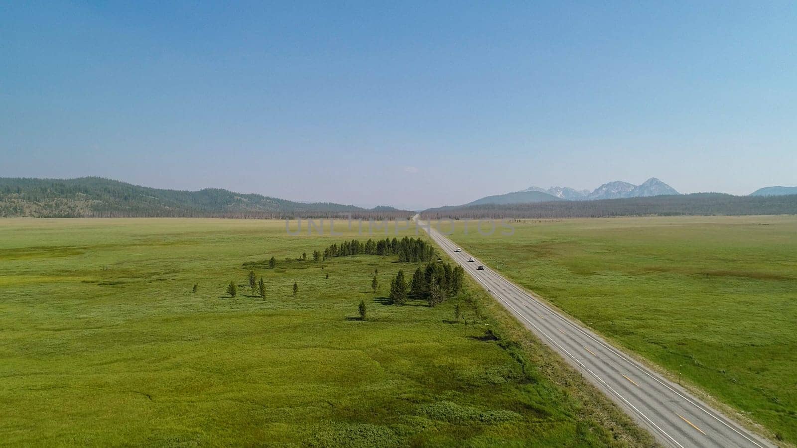 aerial view of a road against a green valley as seen from a drone or a birds eye view