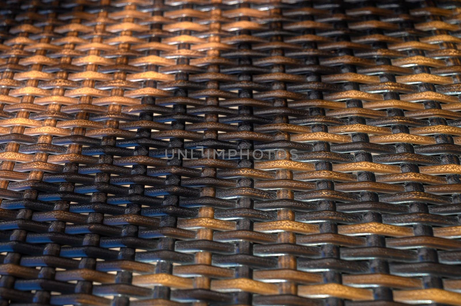 Textured weaving showcases a dance of light and shadow in a cozy outdoor space during the golden hour.