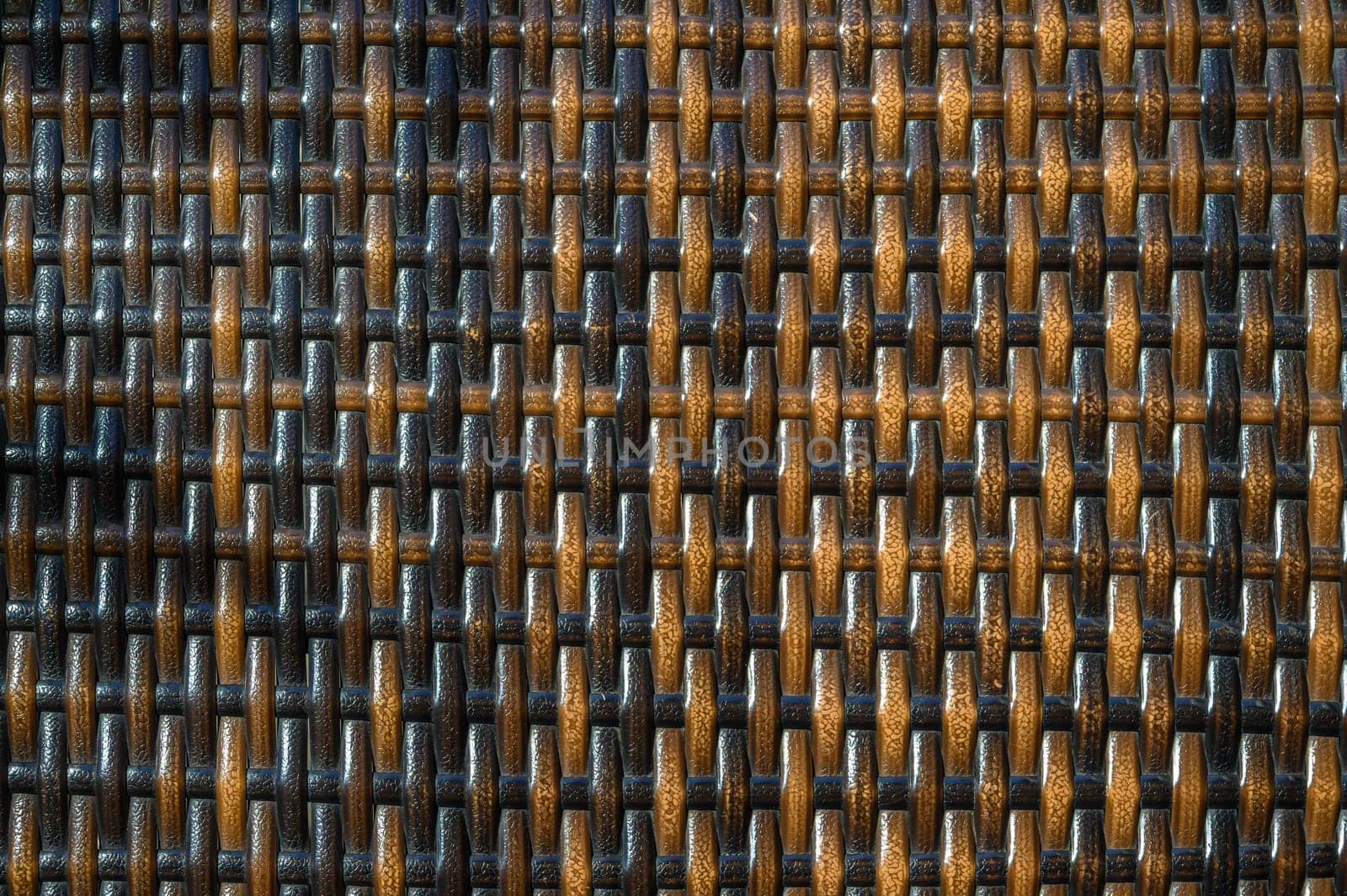 Delicate interlacing of dark and light strands forms a textured backdrop reflecting natural warmth and artistry.