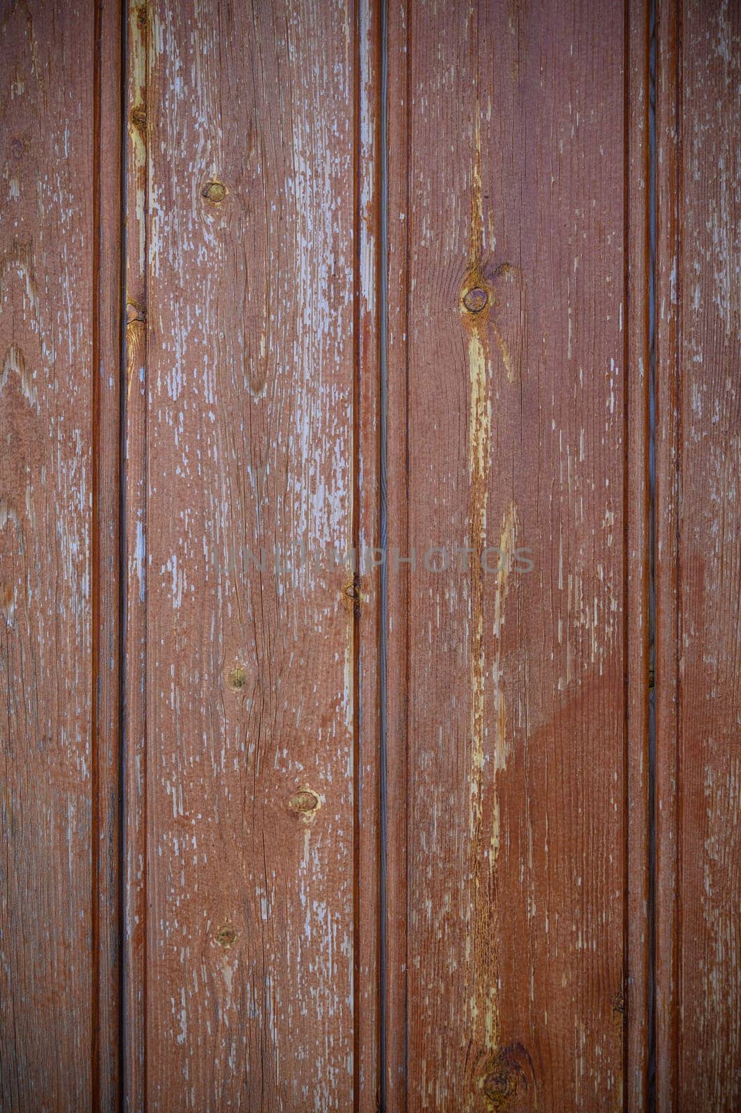 Textured red wood panels evoke warmth and nostalgia, creating a cozy backdrop for artistic creativity and inspiration.