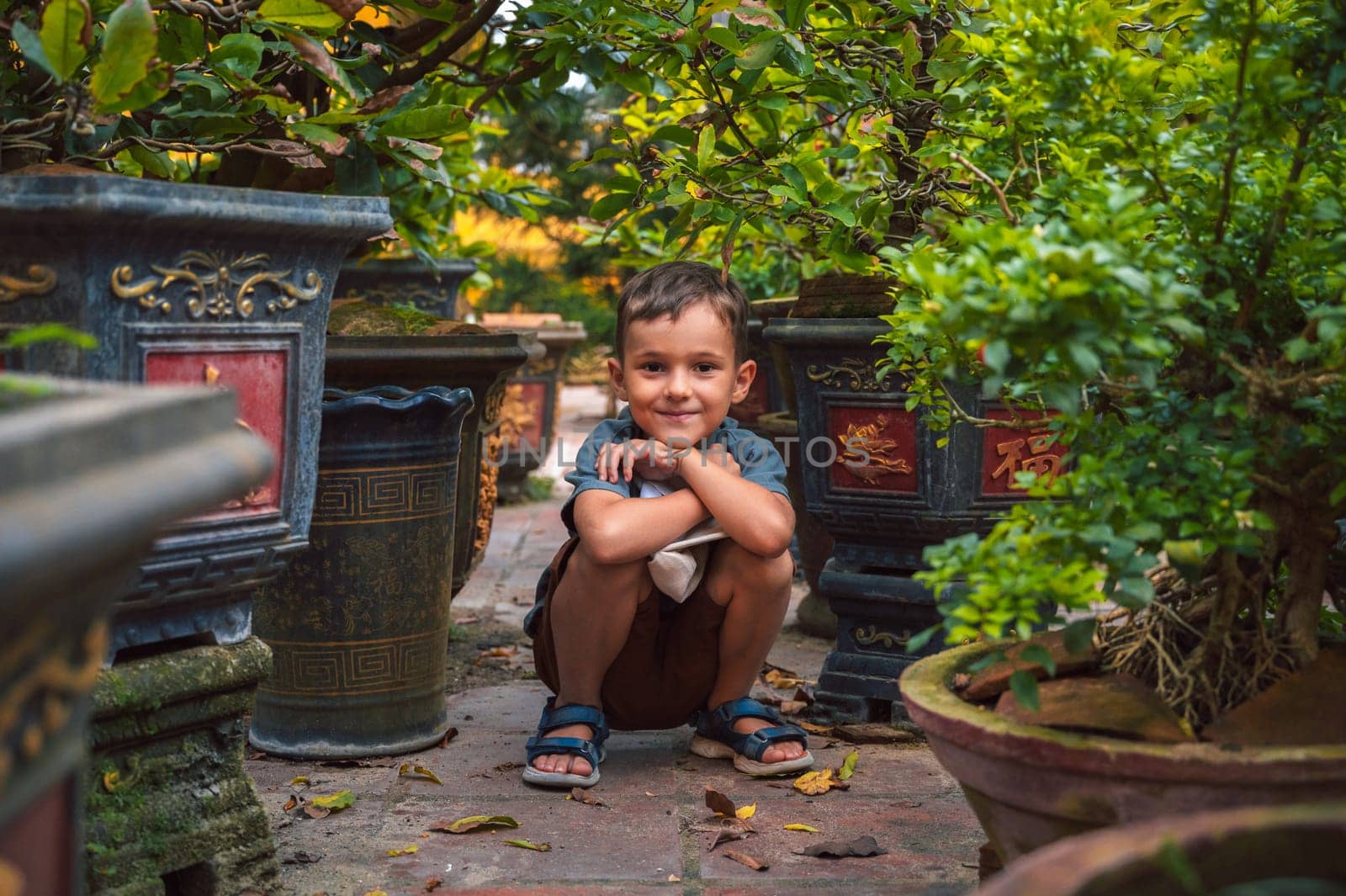 Portrait of a happy caucasian schoolboy kid boy on a park in summer