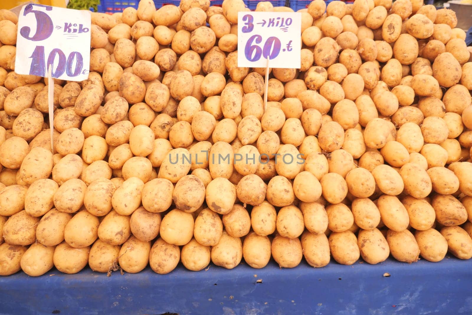 Abundant potatoes stacked neatly for sale in a bustling market.