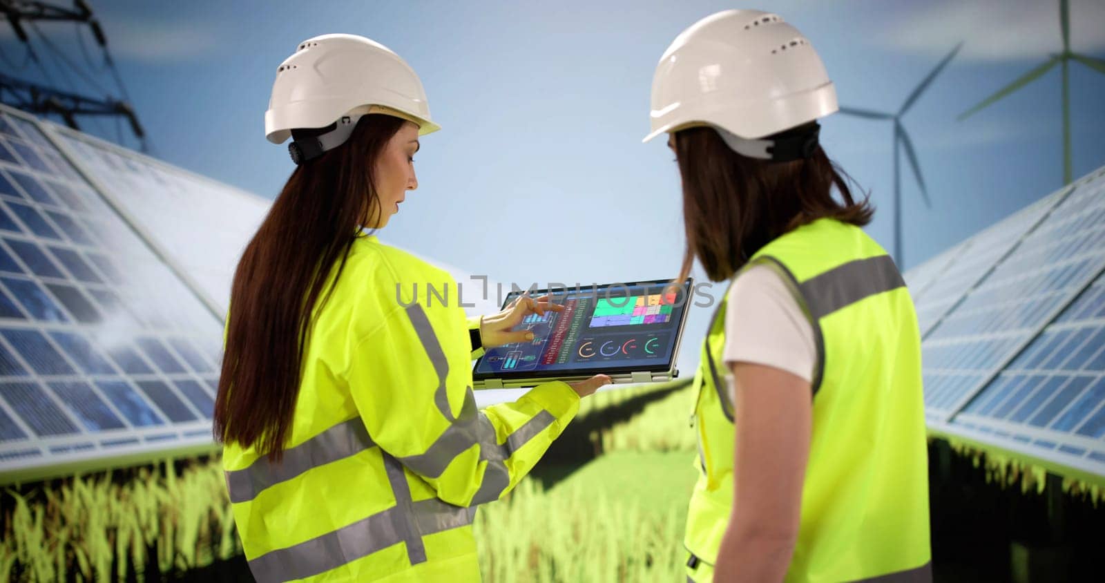 Two young women engineer inspecting solar panels for photovoltaic energy.