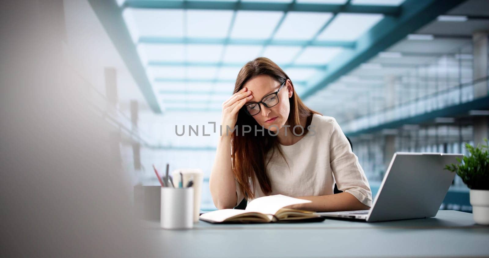 Young woman learns online in virtual webinar using laptop computer.