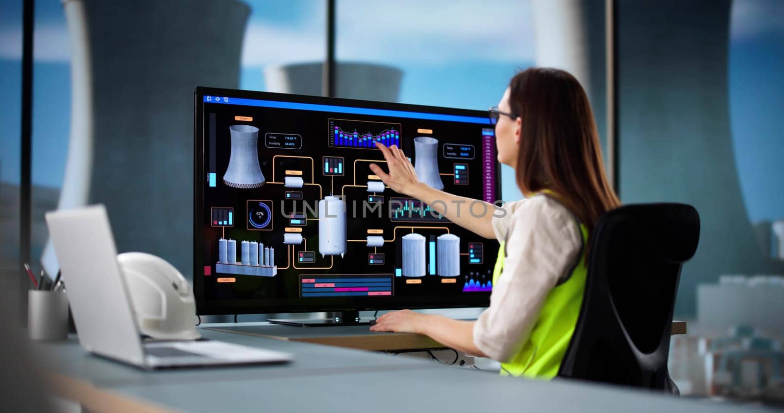 Female Professional Monitoring Energy Production at Nuclear Power Plant Control