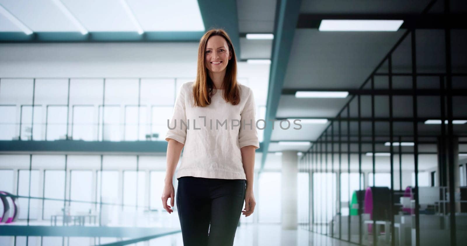Joyful female entrepreneur managing office resources with a smile on face.