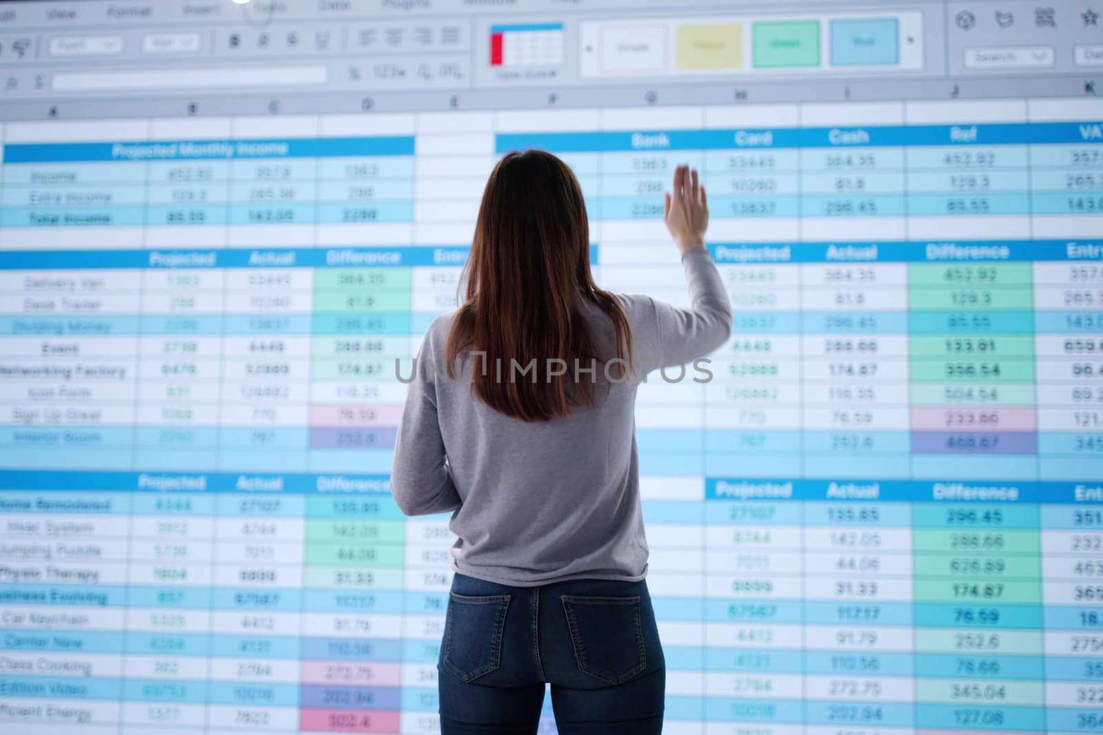Young businesswoman using spreadsheet to calculate medical billing records accurately.