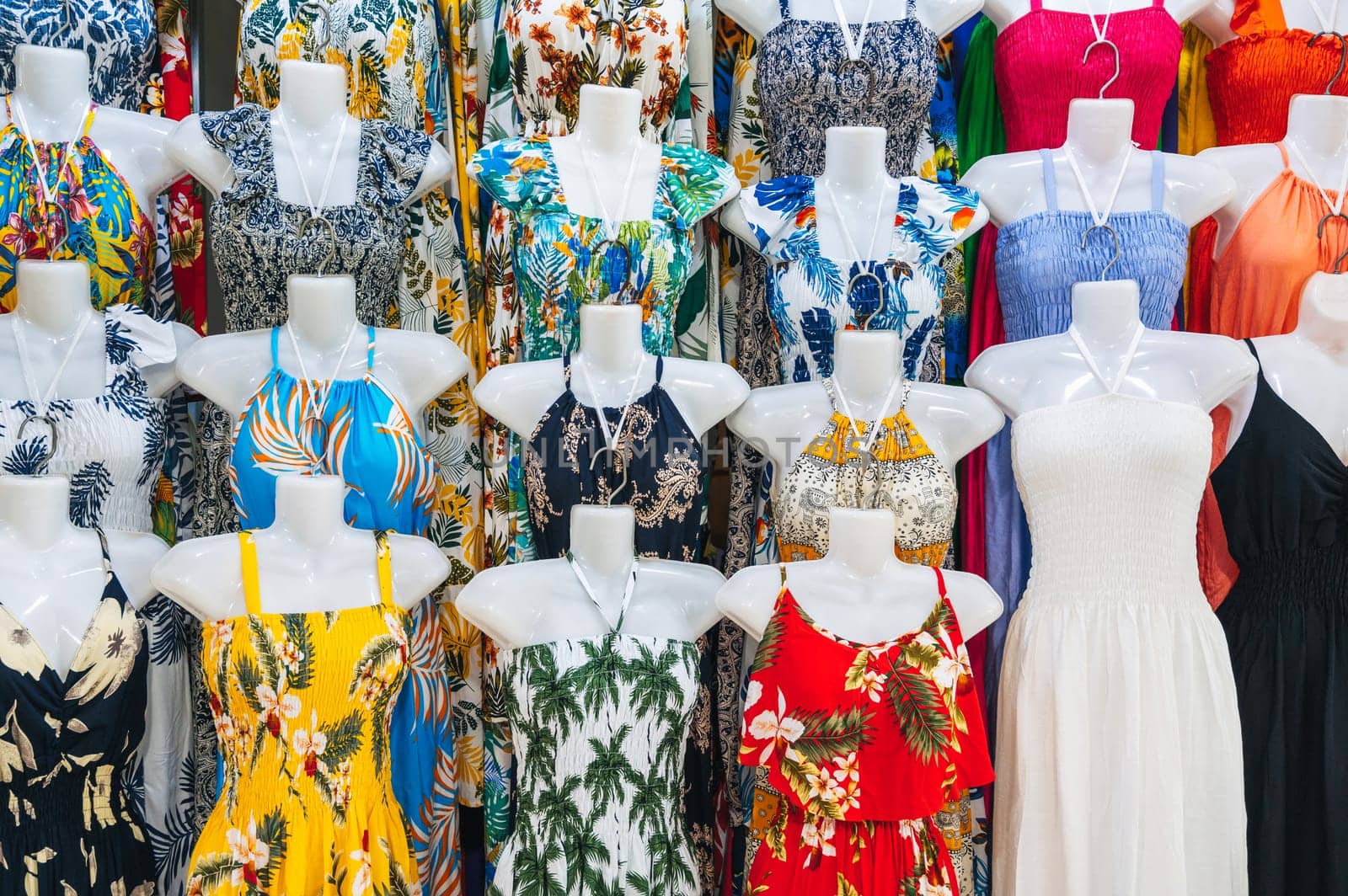 female colorful summer dresses on mannequins on the market in Asia