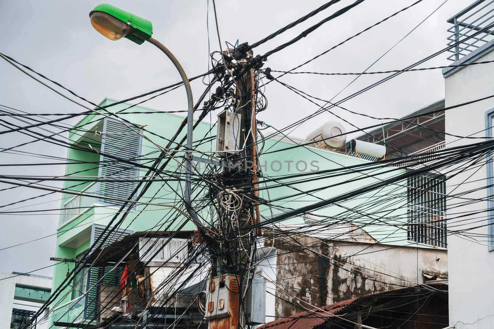 mess in the electricity wires on the street in a city in Asia in Vietnam