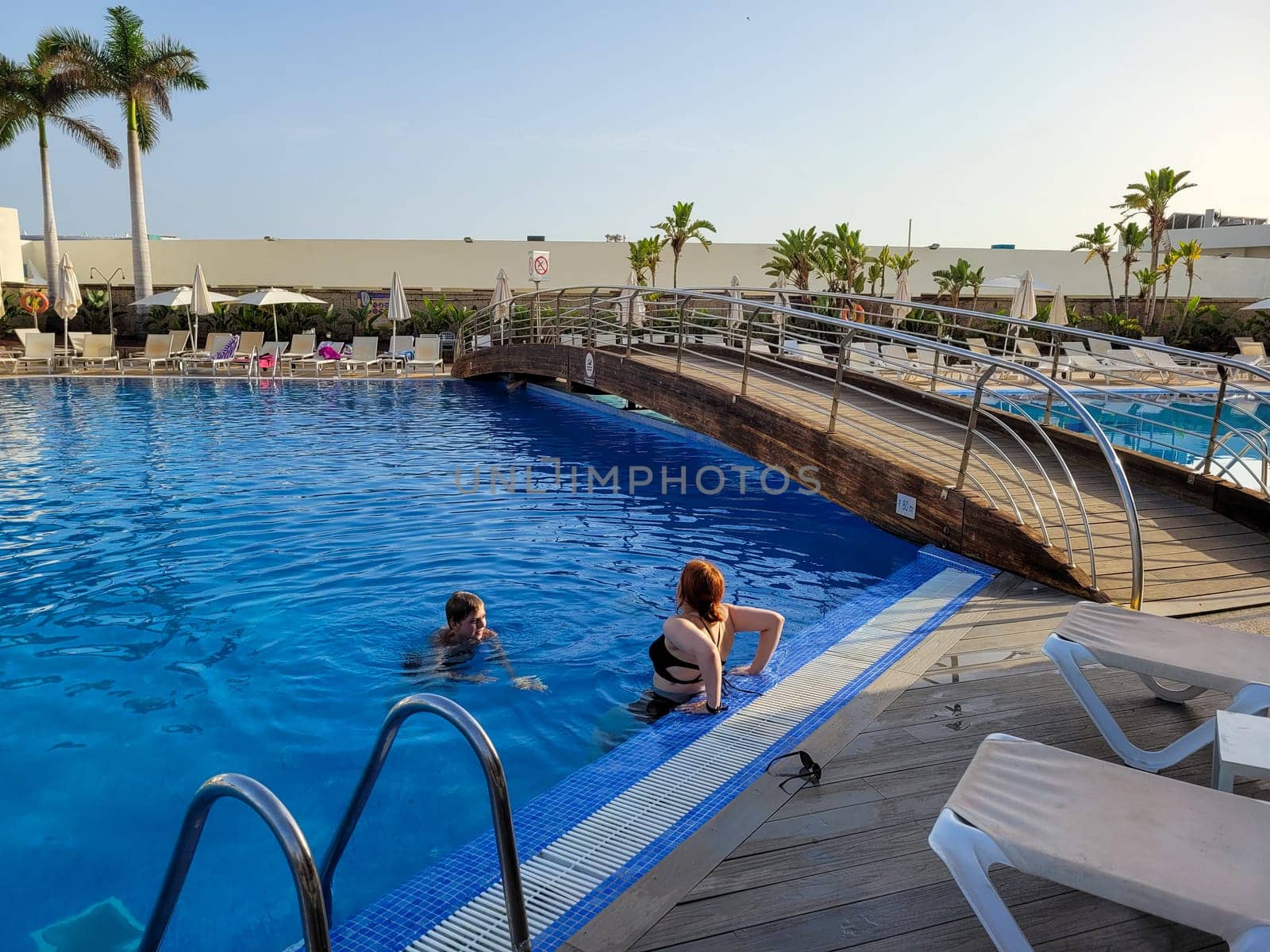 A boy and a teenage girl in a swimming pool