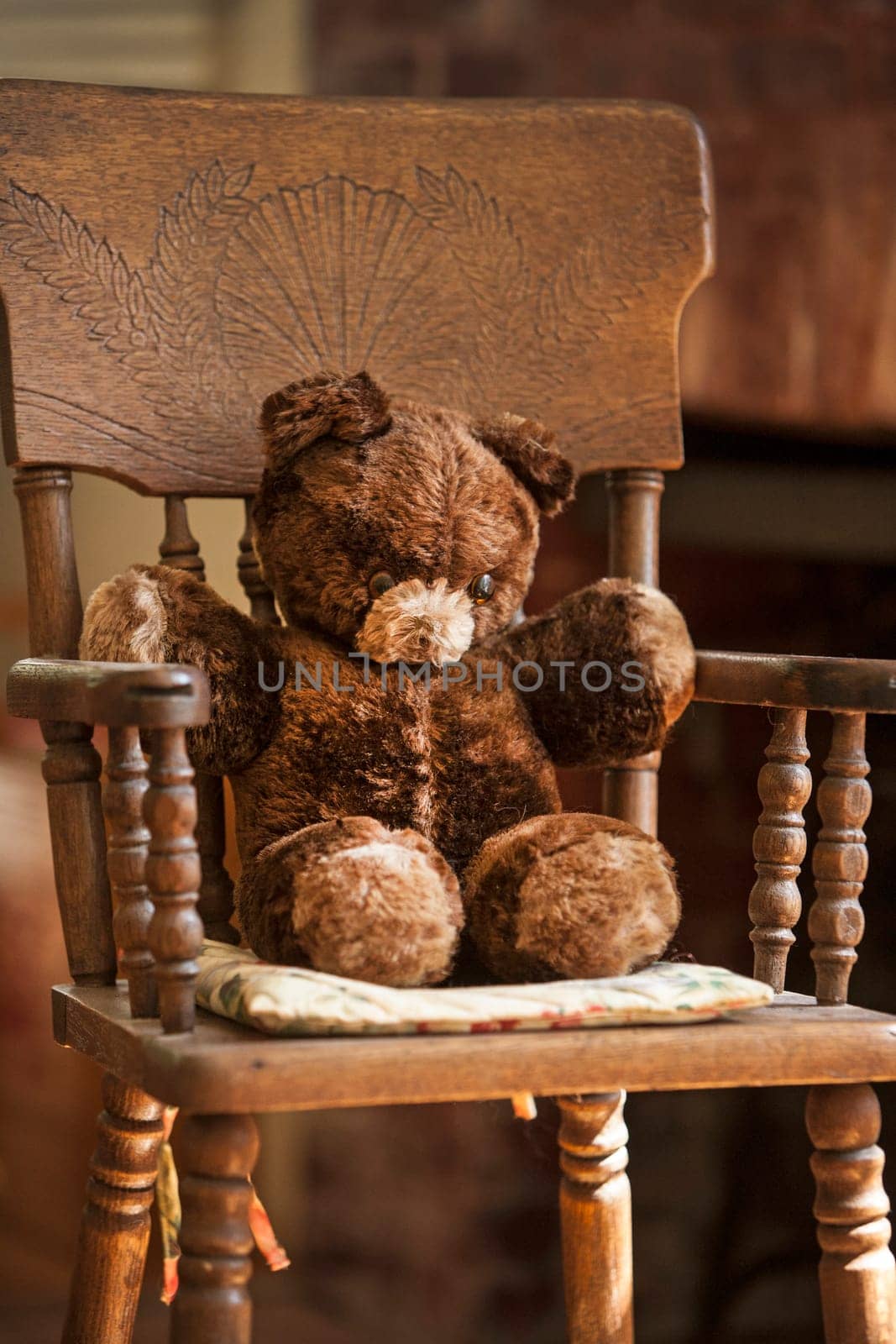 Teddy bear sitting in a chair.