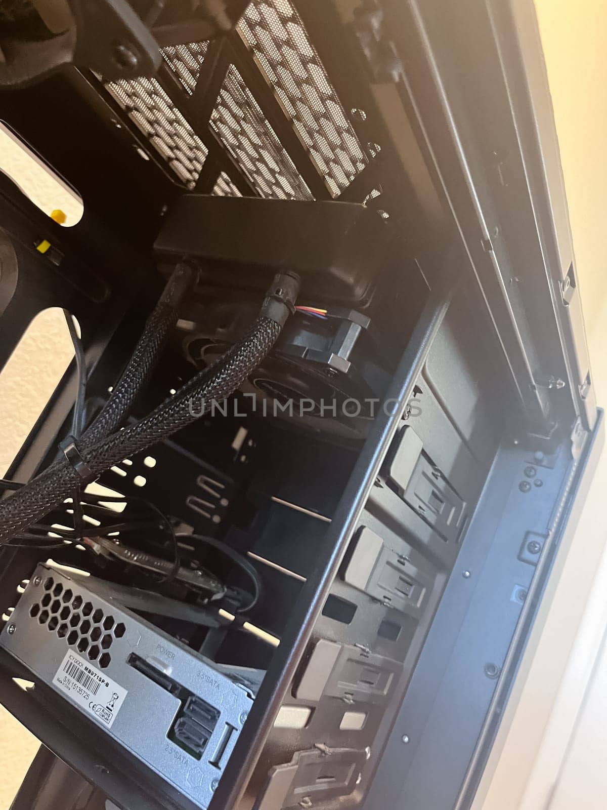 Castle Rock, Colorado, USA-August 18, 2024-A custom built gaming PC with an open side panel revealing internal components The build features a Radeon graphics card liquid cooling system multiple storage bays and a high performance power supply The black case has ample ventilation and cable management for optimal airflow Ideal for gaming enthusiasts and PC builders