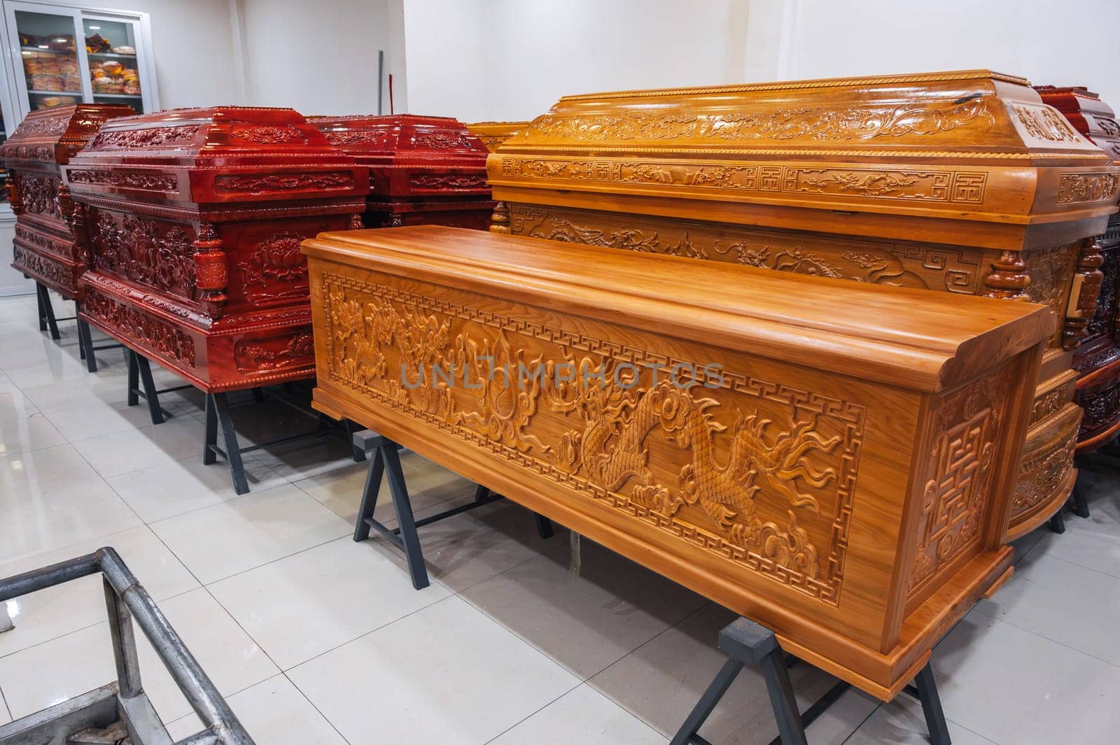 wooden coffins with traditional Asian ornament in a funeral home in Asia