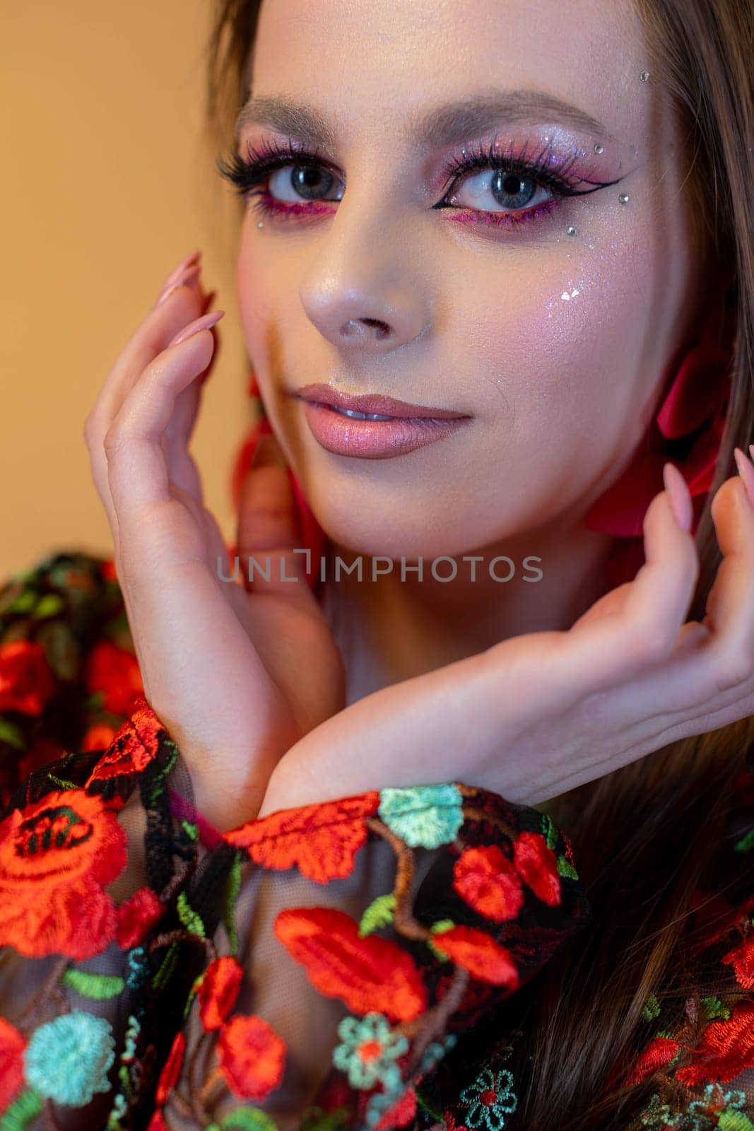 An enchanting portrait of a woman brilliantly showcasing her bold and striking makeup alongside a vibrant floral outfit