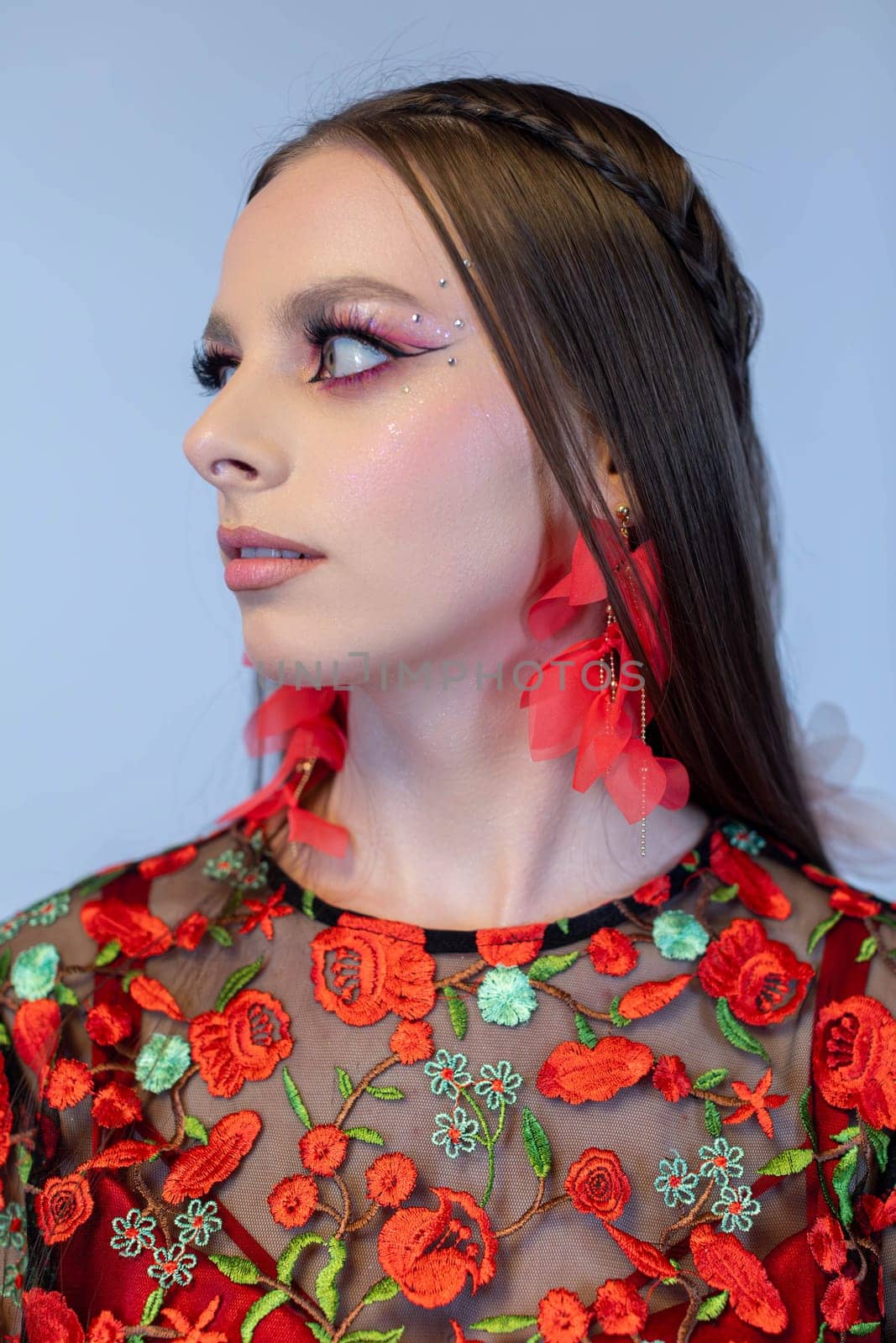 A captivating portrait showcasing bold fashion, intricate floral details, and vibrant makeup artistry