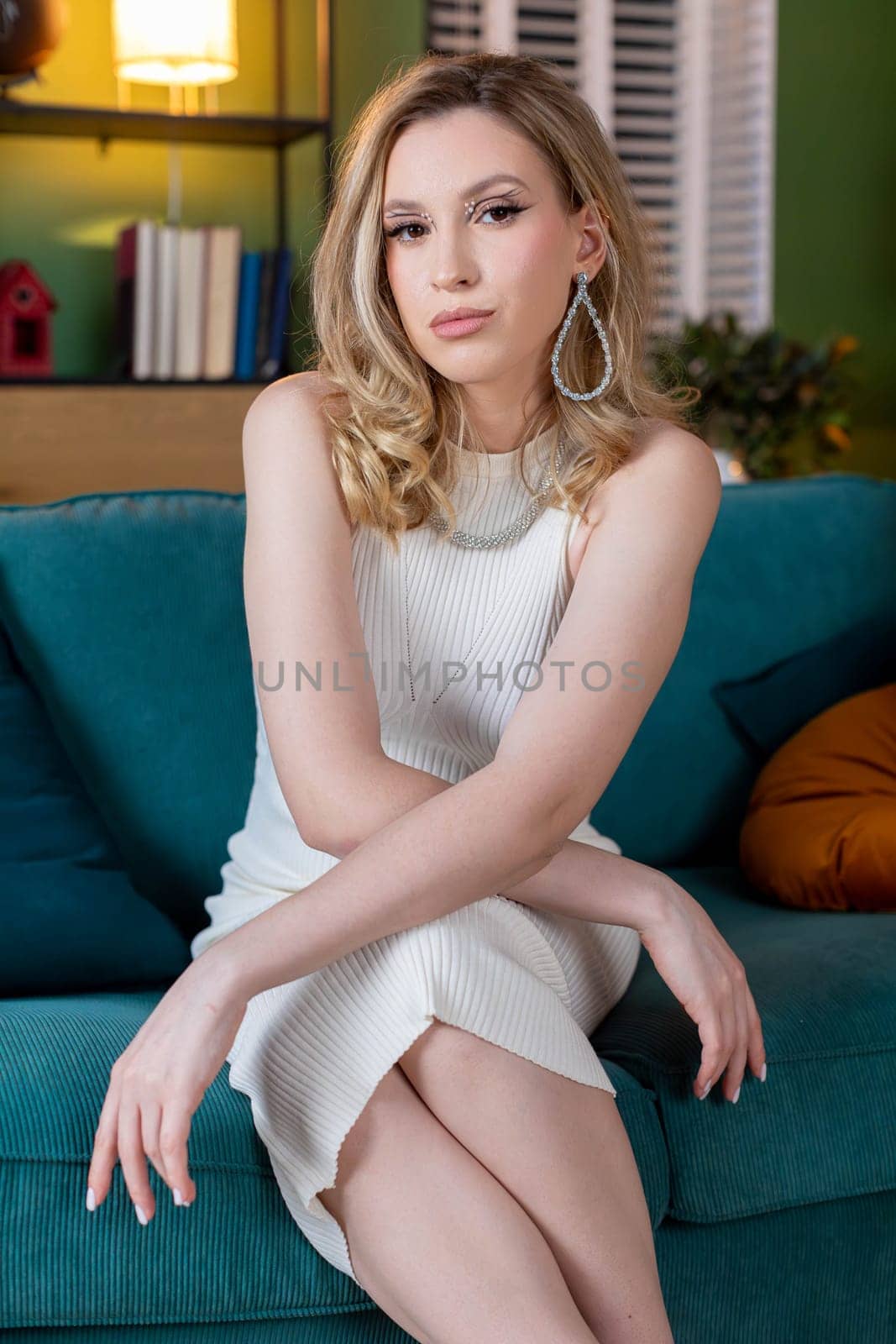 A poised and graceful fashion model is elegantly showcasing her beauty within a beautifully designed modern interior