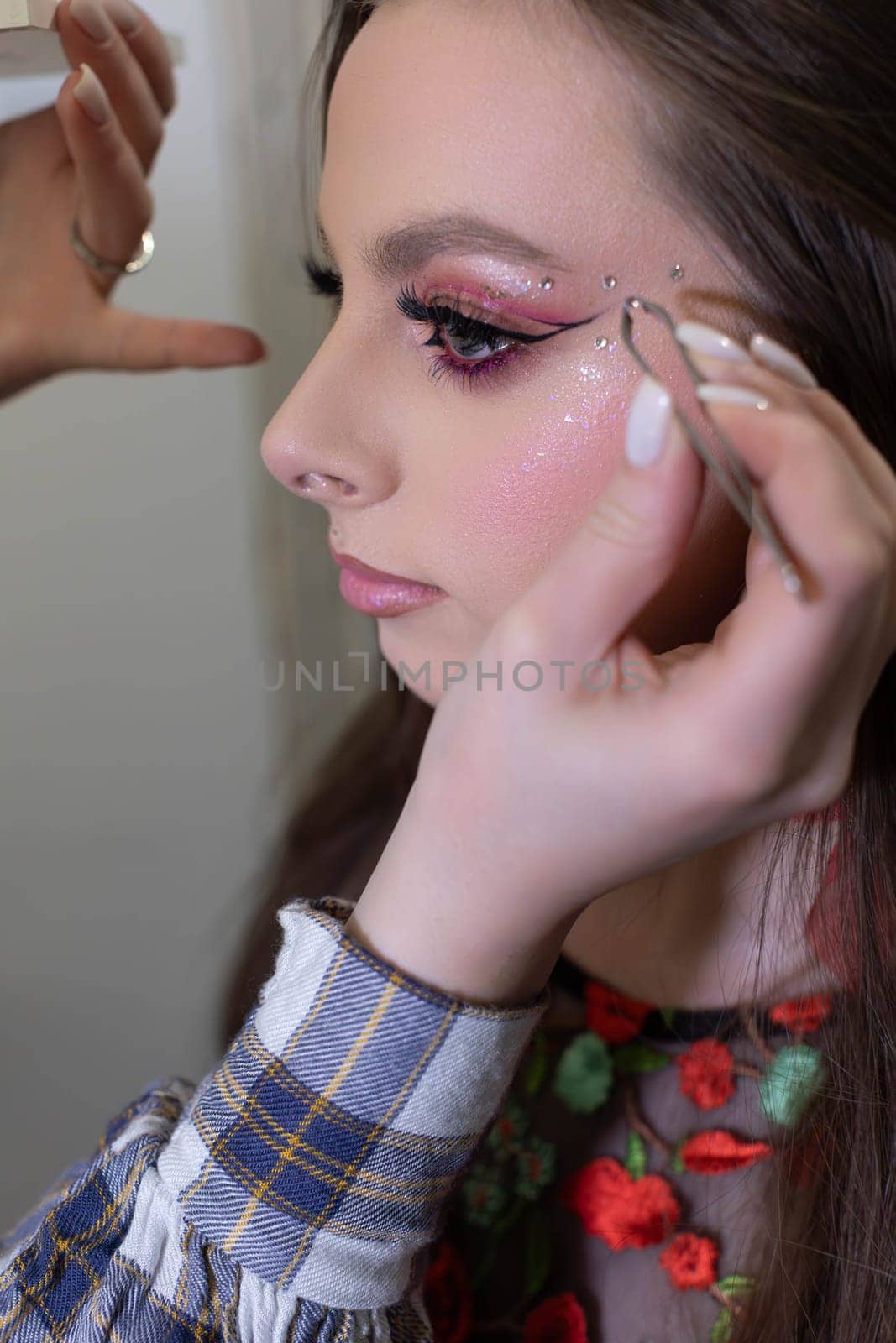 A highly skilled professional makeup artist enhances a clients look beautifully with intricate detailing techniques