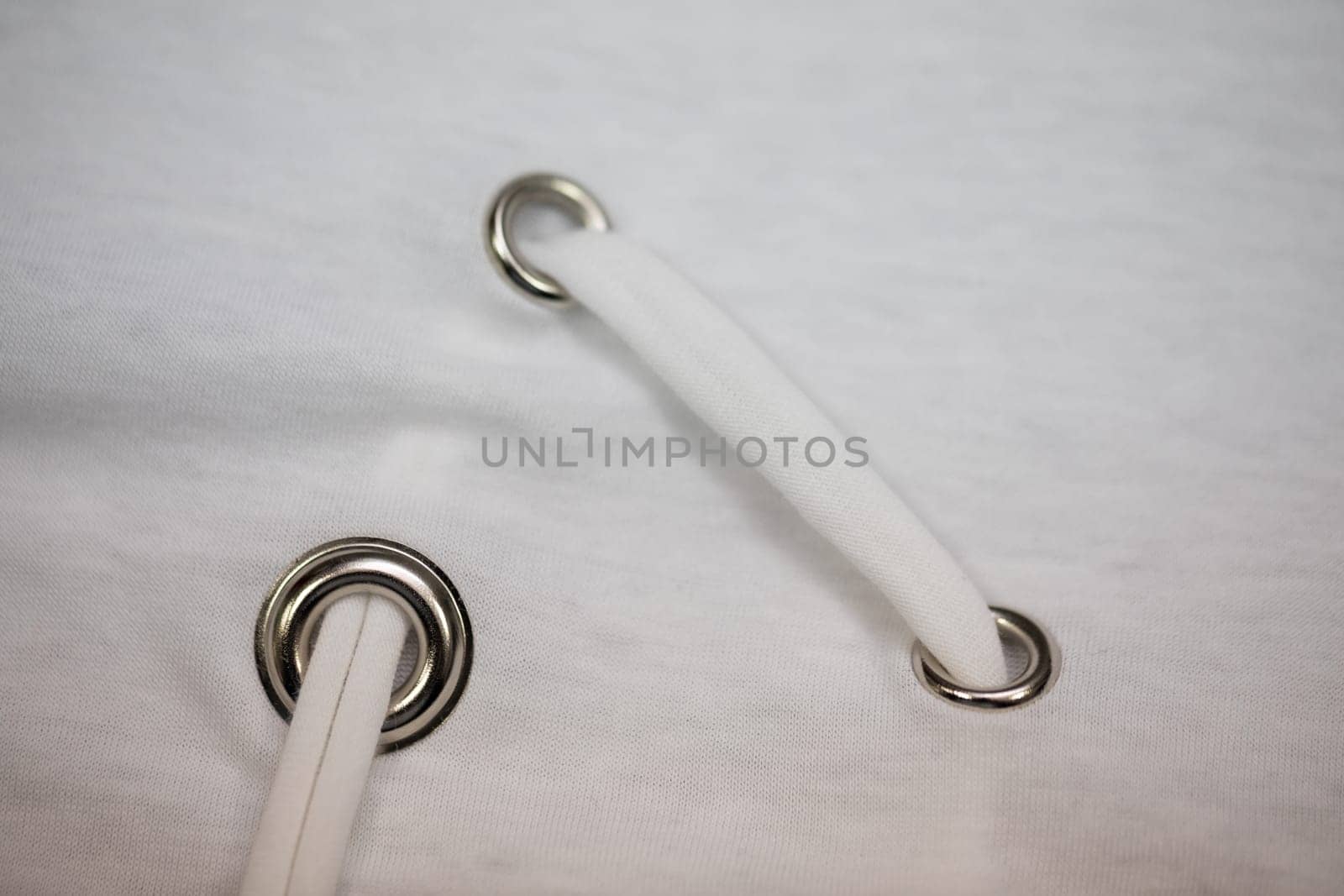 This is a detailed view showcasing grommets, along with white rope utilized in various fabric applications