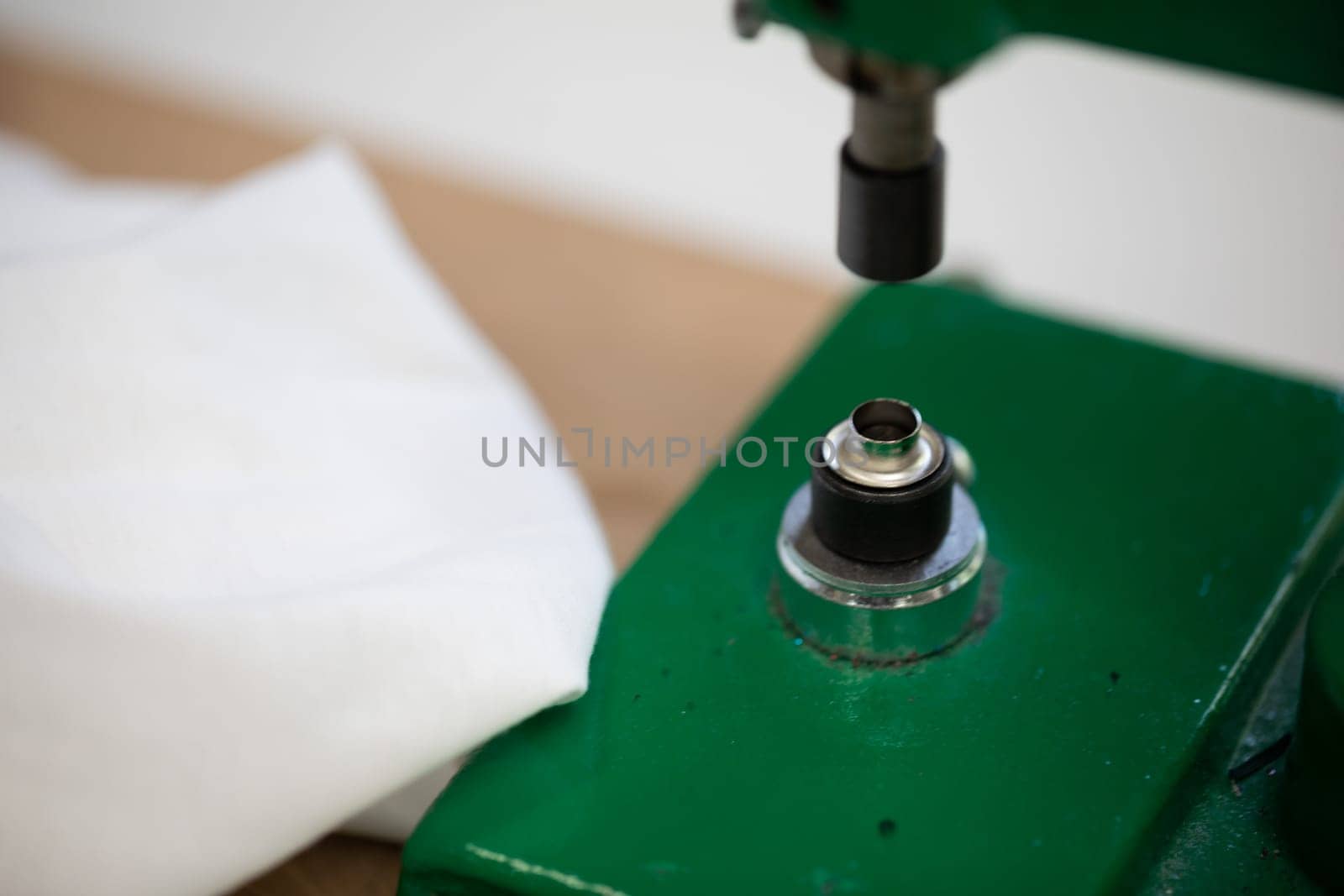 A closeup view of a vibrant green fabric press machine that is utilized for both crafting and sewing purposes